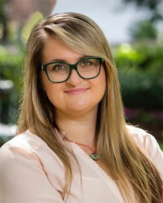 A blond woman in glasses
