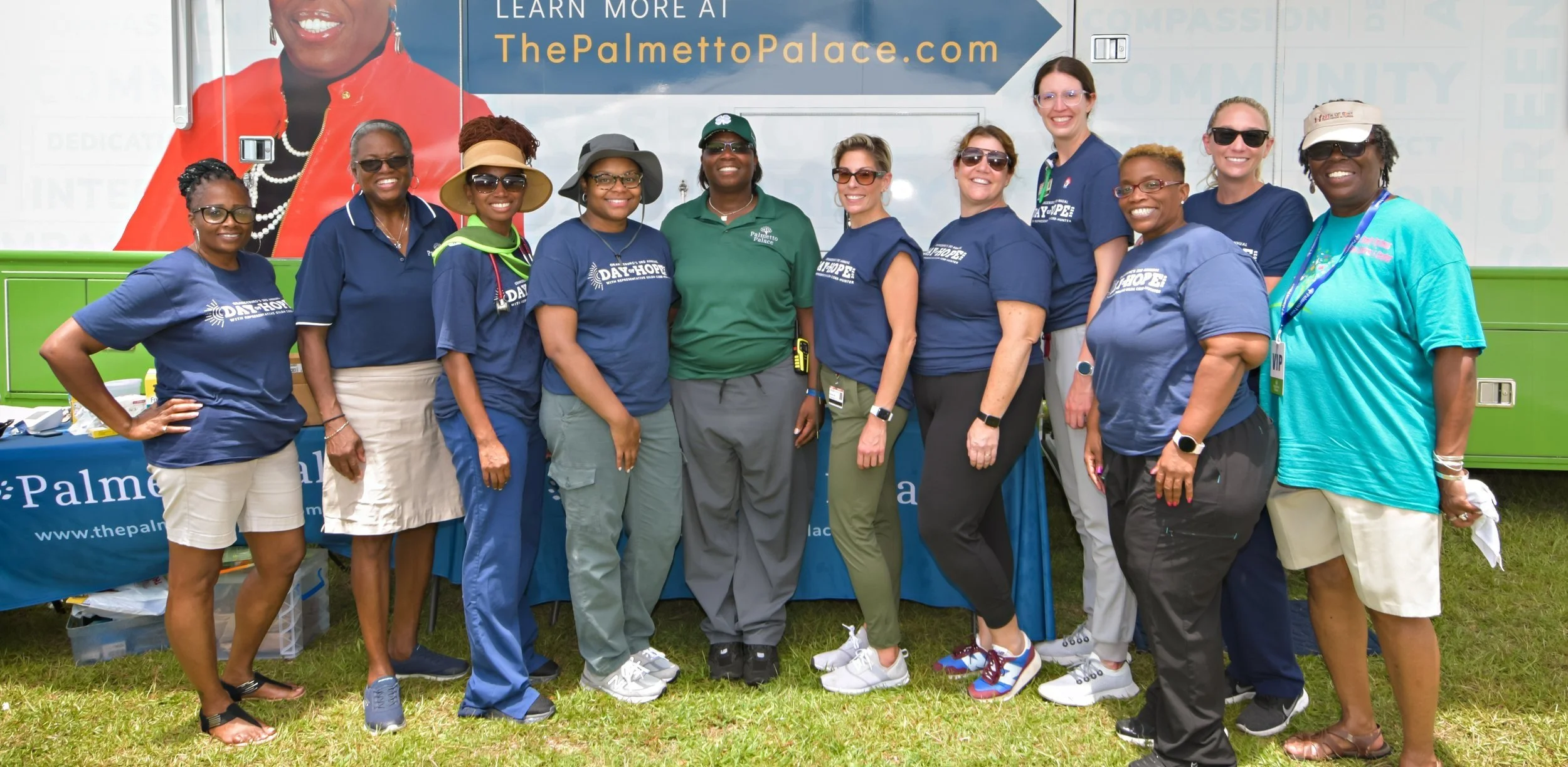 A group of people standing in front of a mobile clinic