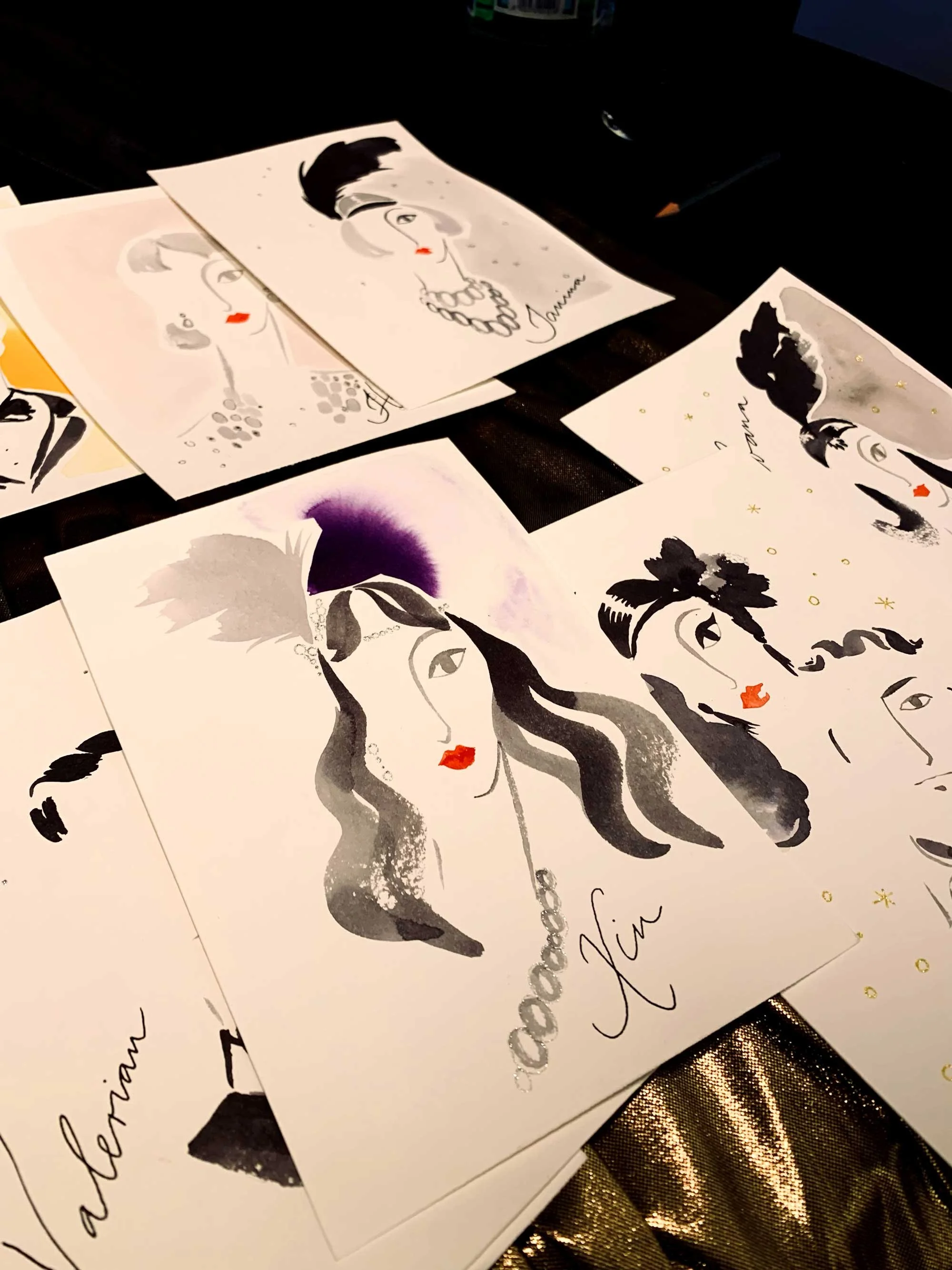 Collection of fashion illustrations featuring women with varied hairstyles, makeup, and accessories, signed by Amy.