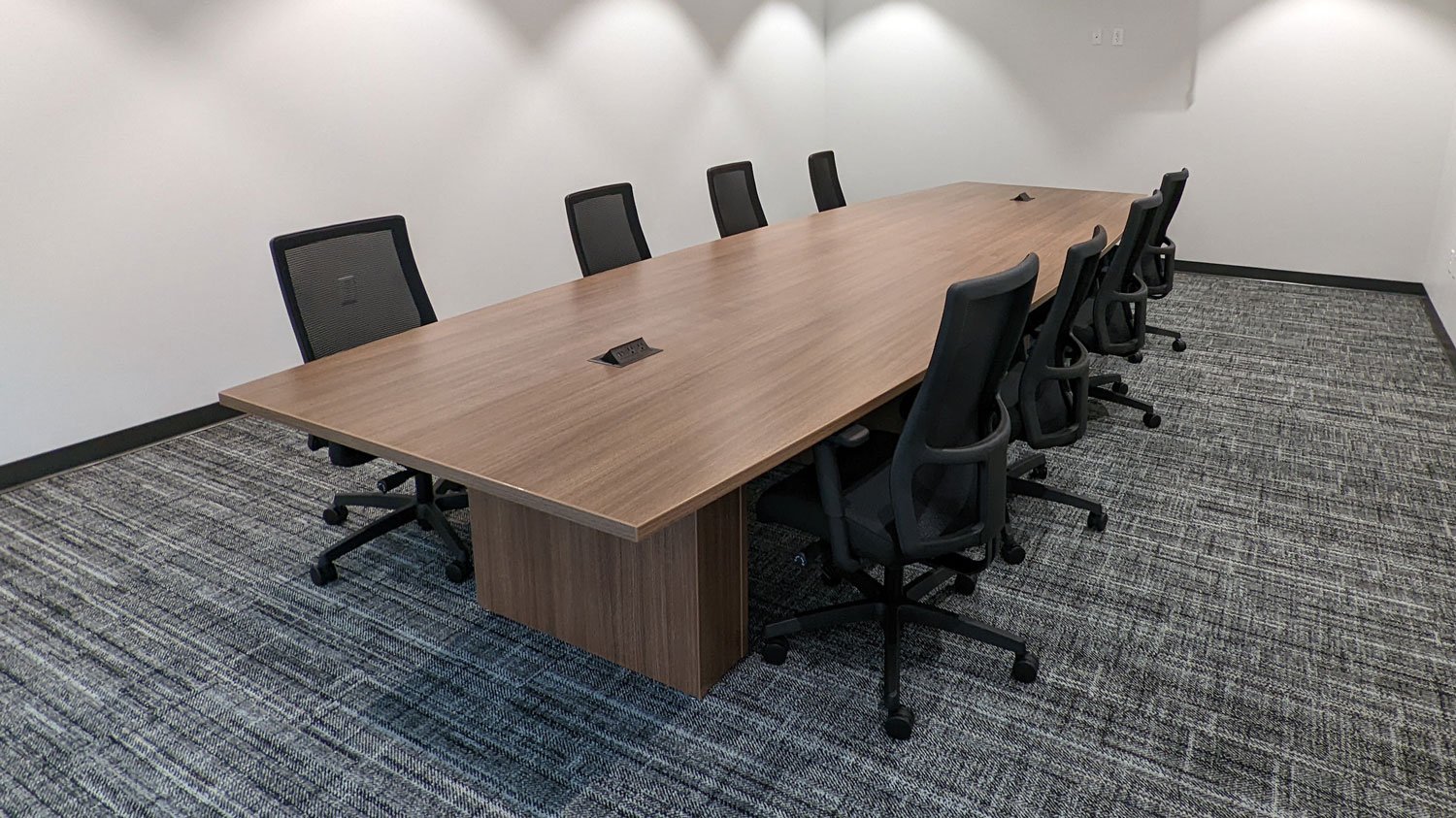 Rectangular conference table with panel bases and power/data ports