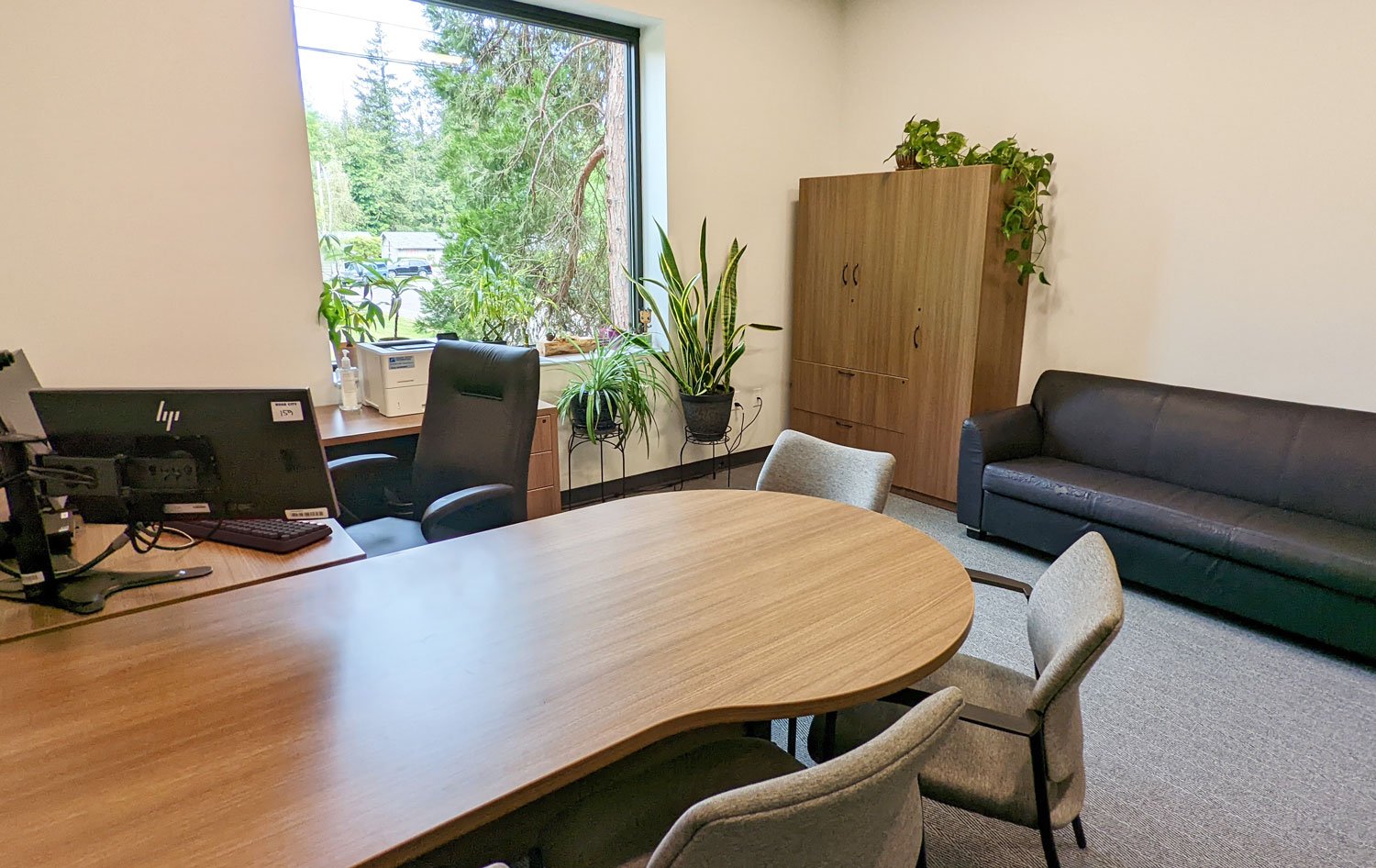 Private office with height adjustable desk and P-top peninsula return and storage cabinet