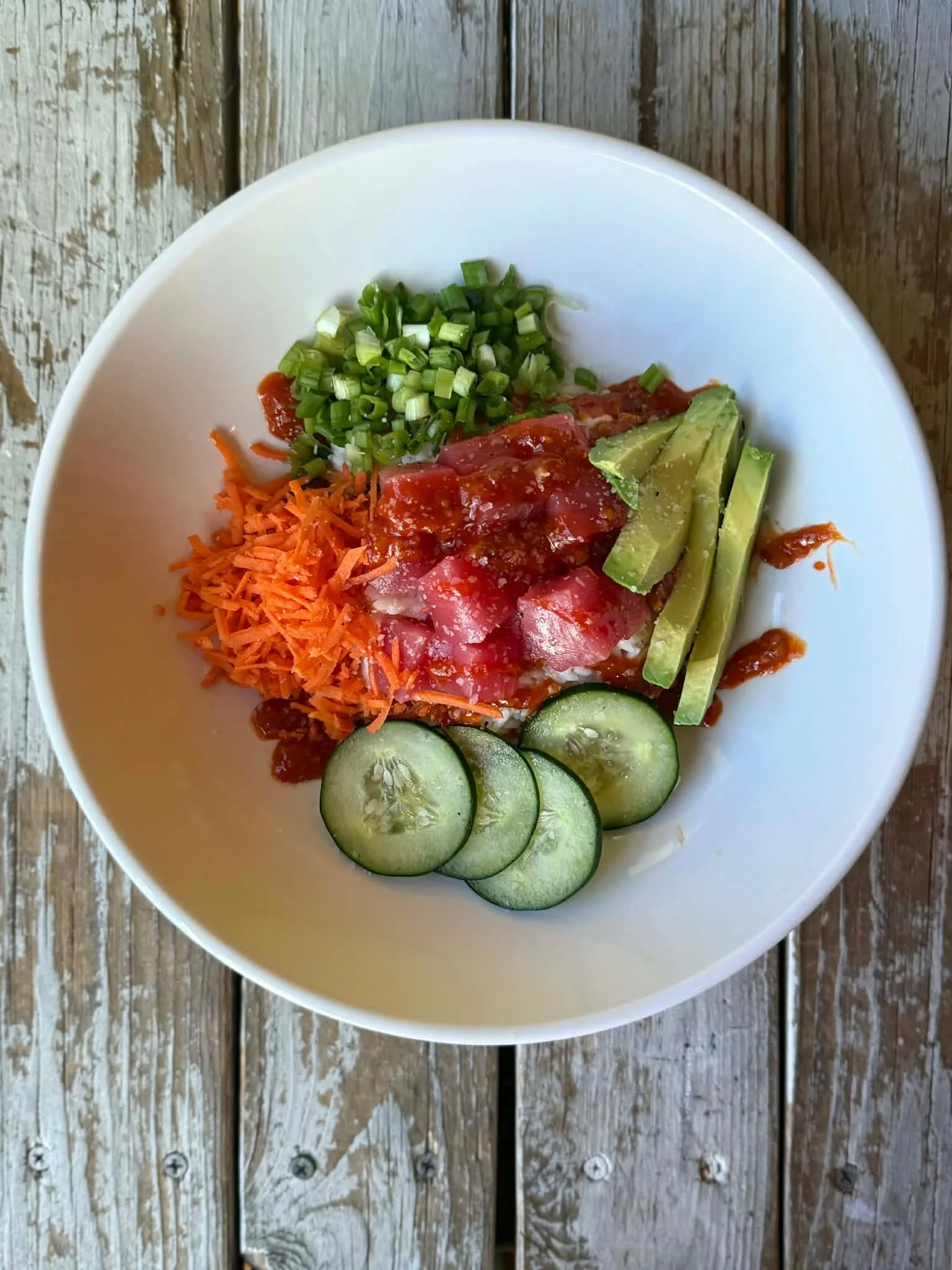 Tune Rice Bowl: tender tuna, umami sauce, avocado, cucumber, carrot and scallions over rice