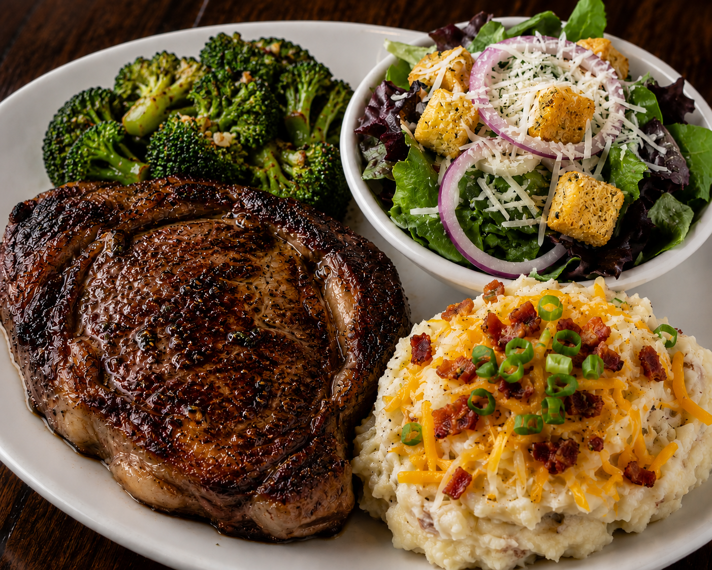 120z Ribeye served with sauteed broccoli, loaded mash potatoes and a half house salad