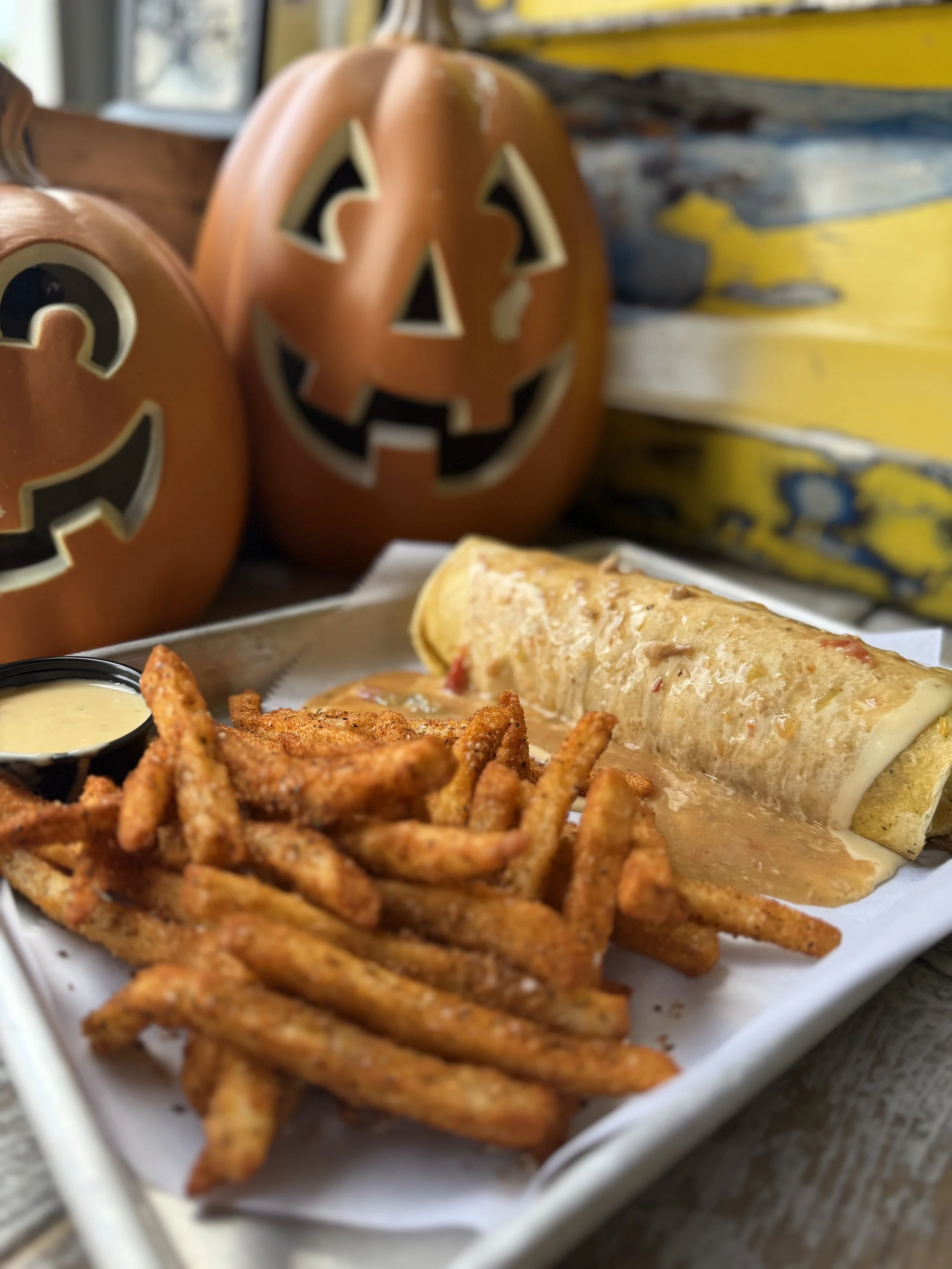Double marinated ribeye strips, red and green peppers and onion, cheddar jack cheese, cheddar jalapeno tortilla smothered with nacho cheese and Colorado green chili with a side of dry rub fries and nacho cheese dipping sauce