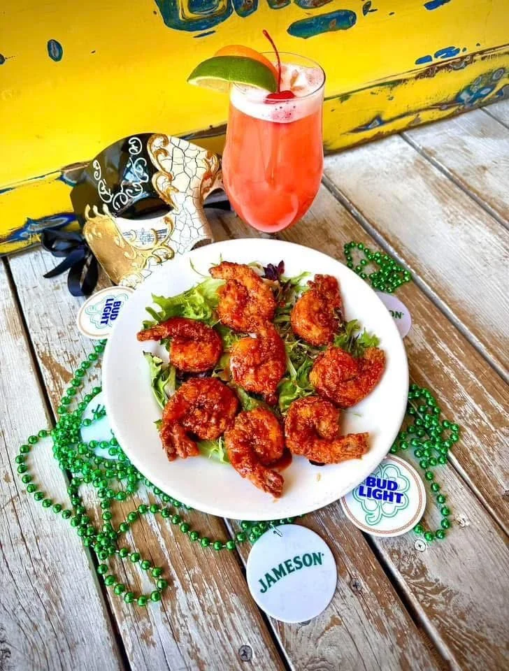 Voodoo Shrimp: 8 tail-on shrimp tossed in honey sriracha on a bed of mixed greens