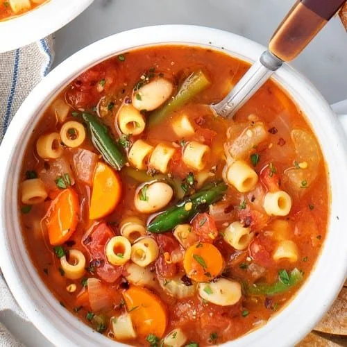 Minestrone Soup topped with shredded parmesan cheese 