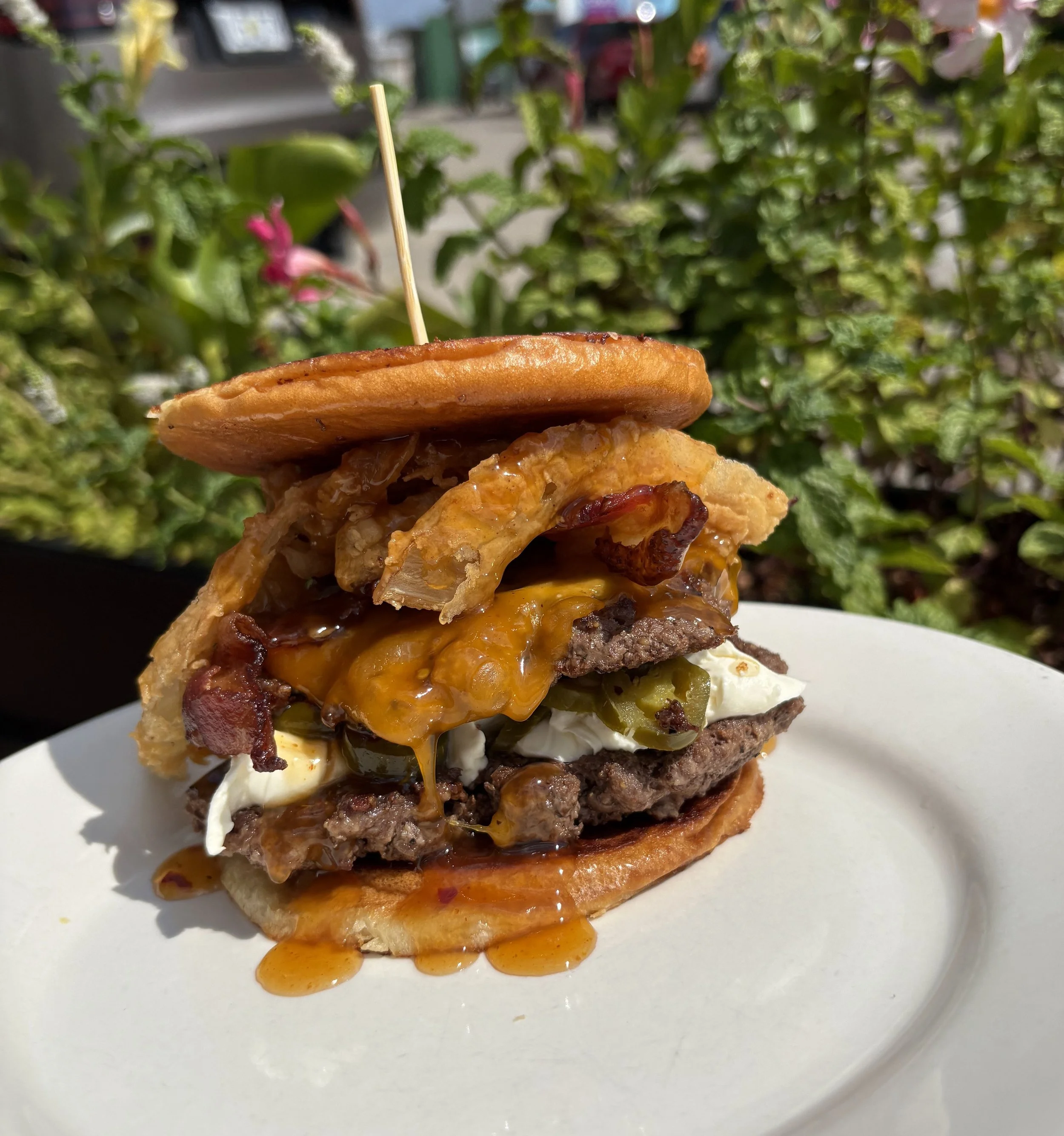 Manager Burger Showdown Week 2:
The Bee-Sting Popper!
Double Beef Smash Patties, Jalapeno Cream Cheese, Cheddar, Onion Straws, & Hot Honey Drizzle on a flipped Hawaiian bun.