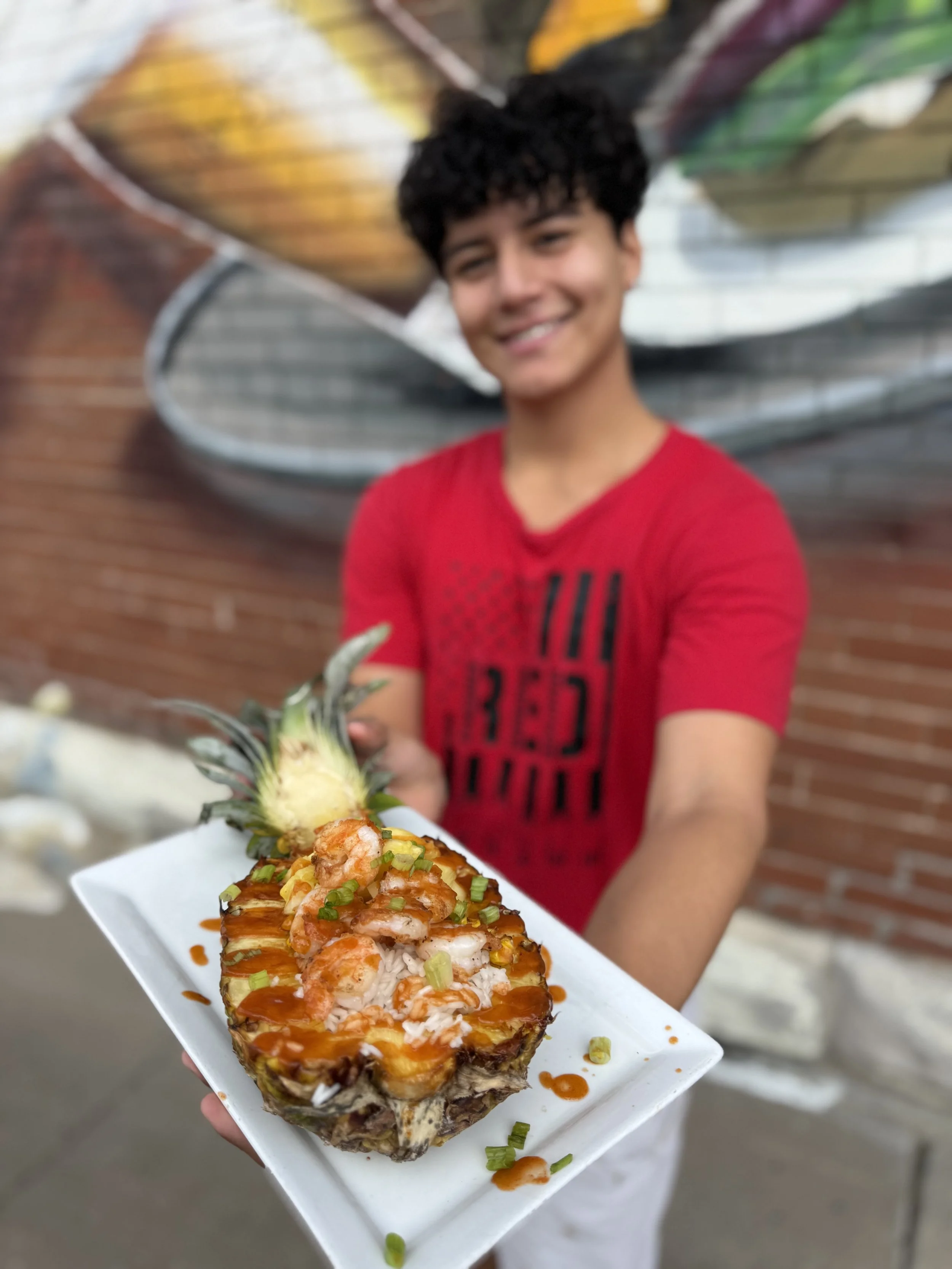 Charlees Pineapple Bowl- grilled pineapple, grilled shrimp, rice, black bean and corn mix, sriracha
