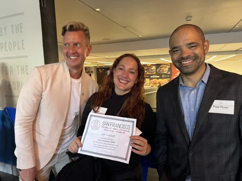Attendees posing with a certificate