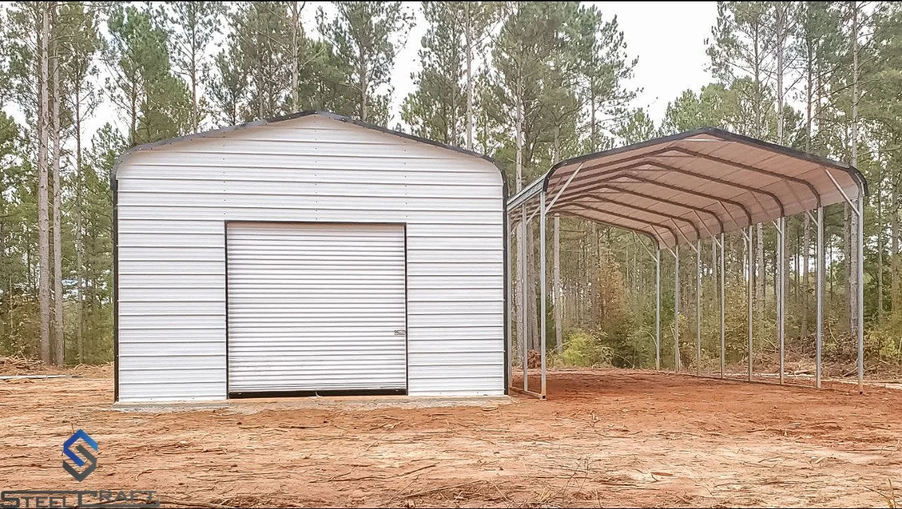 Metal garage and carport in wooded area