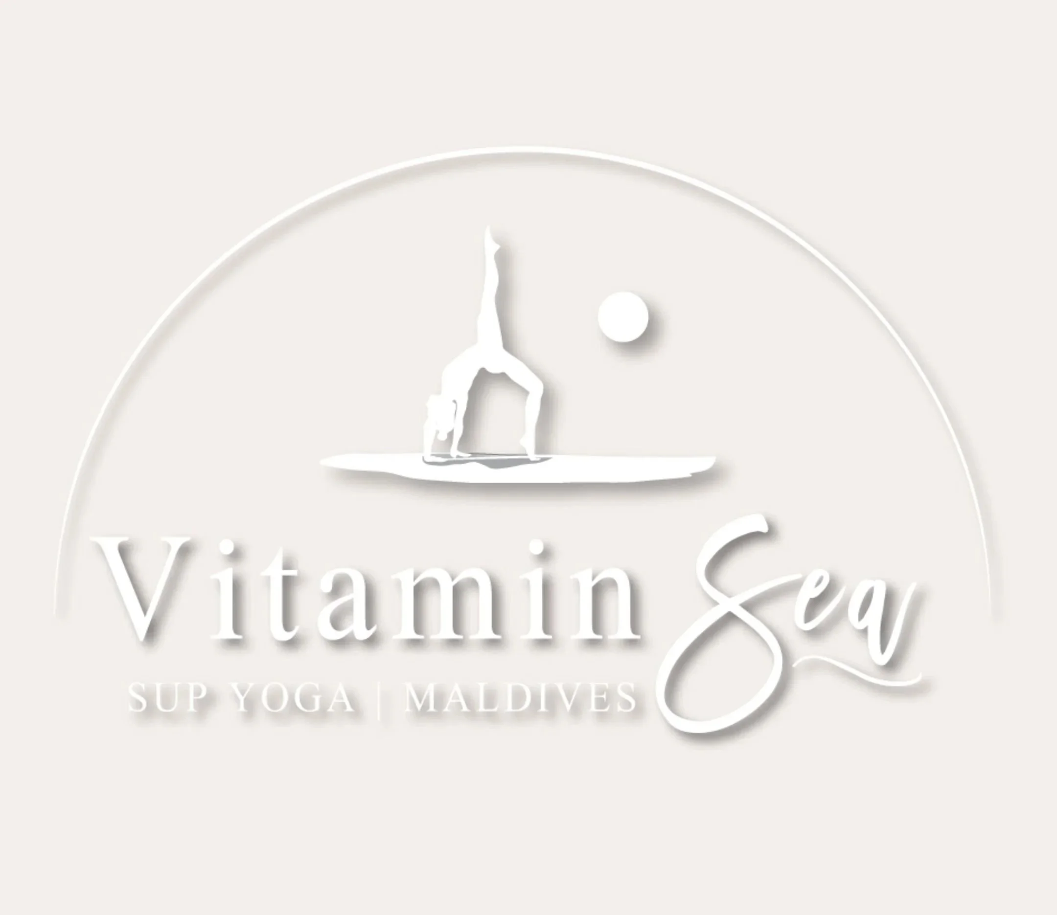 In all white: paddle boarder in yoga pose on board with sun to right & semi circle above. Design is centered over "Vitamin Sea SUP YOGA | MALDIVES".