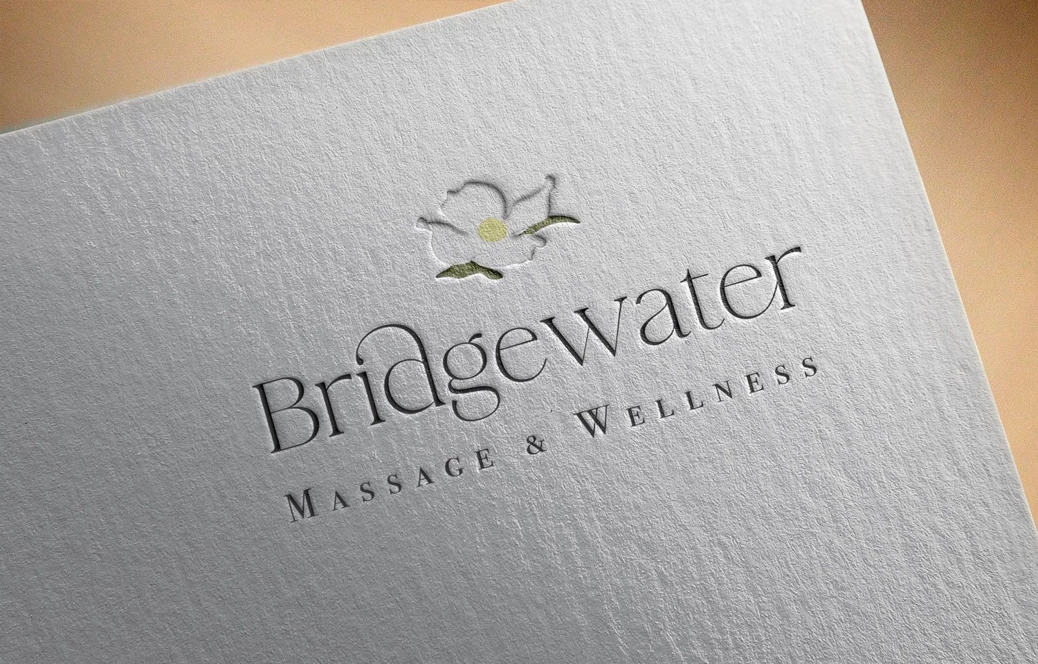 Full color Bridgewater Massage & Wellness logo is mocked up as debossed header on paper