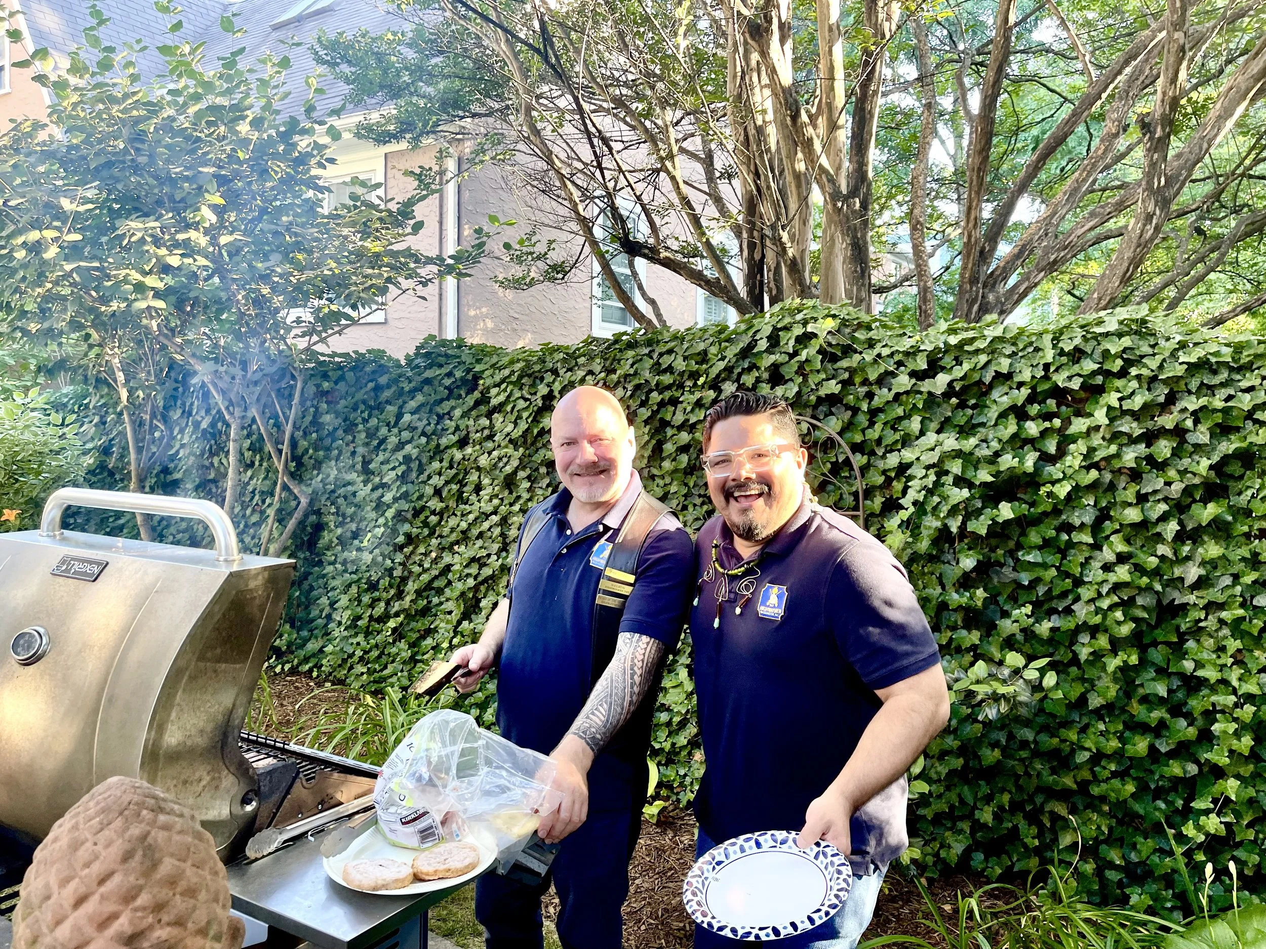 May 2024. Nelson B. and Lola C. cooking some burgers and wieners at the anniversary BBQ.