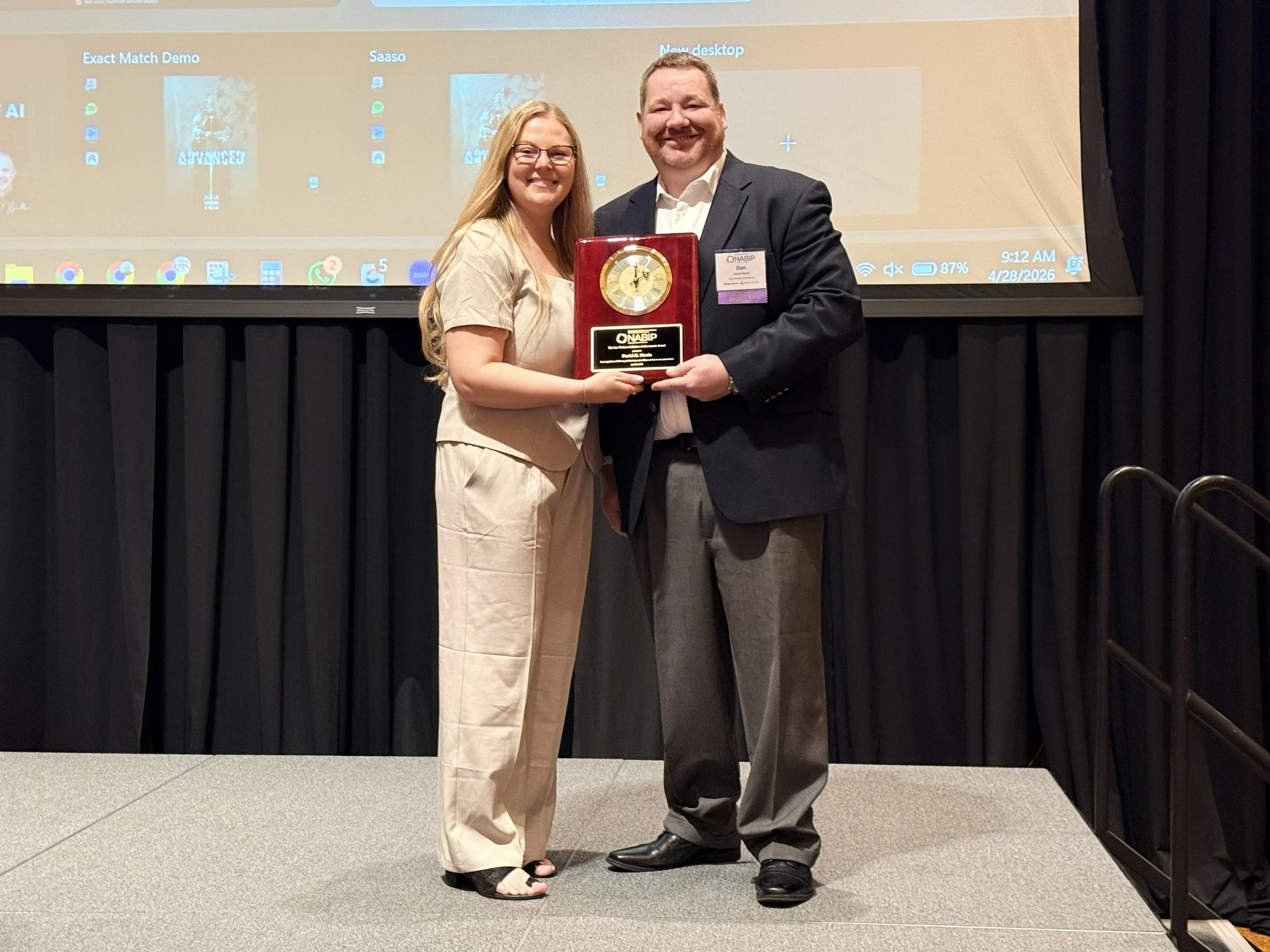 NABIP Columbus President-Elect Alexa Schoonover presents NABIP Columbus Past President Dan Martin with the Annual Lee Nathans Lifetime Achievement Award