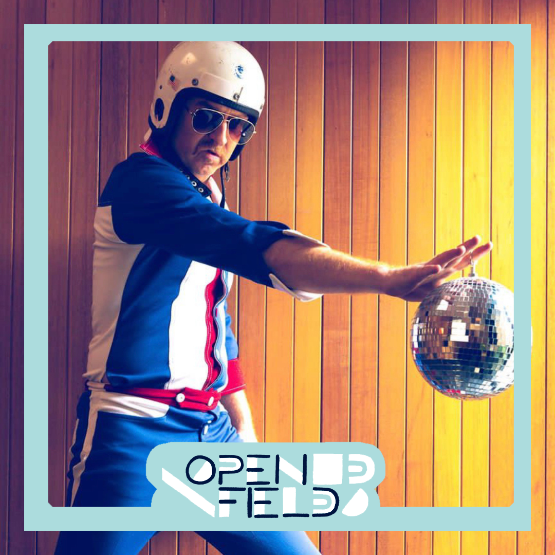 Person in retro jumpsuit and helmet holding a disco ball