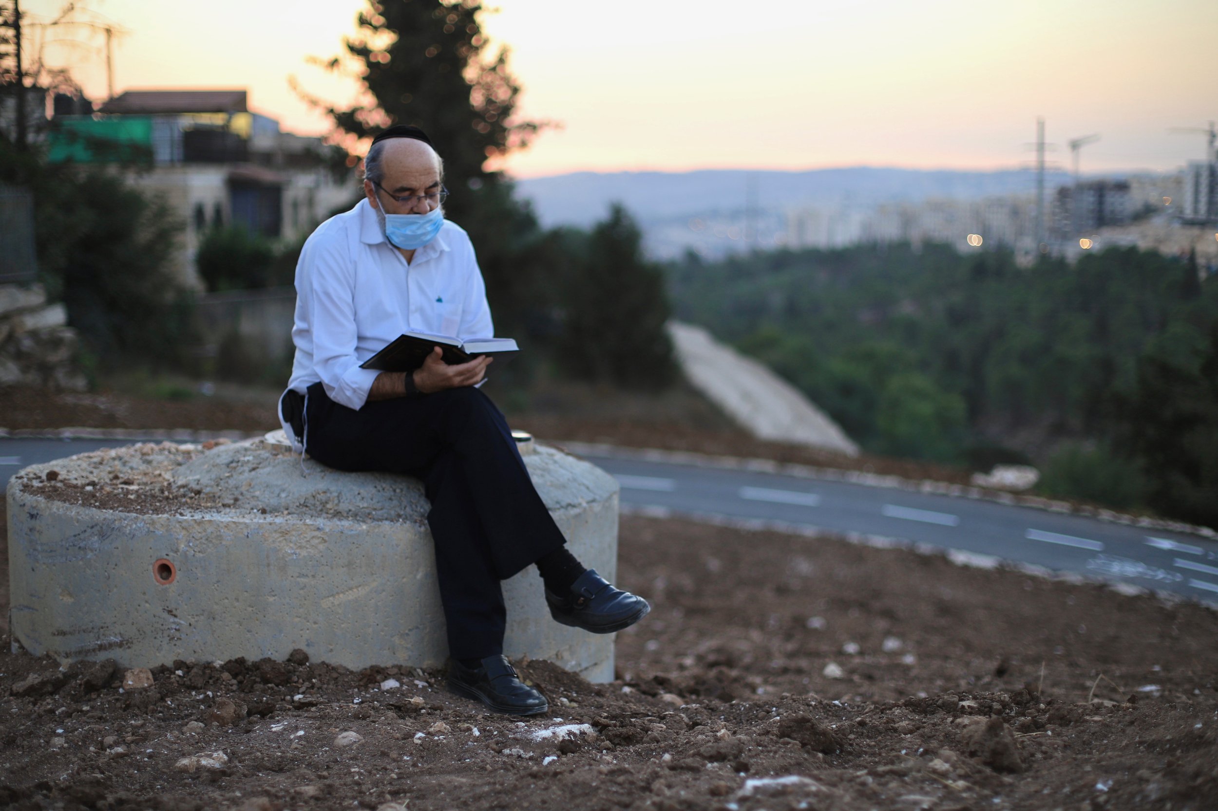 An Orthodox Jewish man reads in a public park during the Sukkot holiday, which had a muted celebration under a COVID-19 national lockdown in Israel. October 2020.