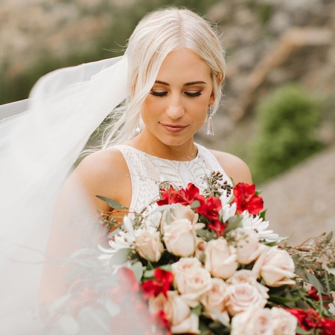 Bride with red and white floral bouquet