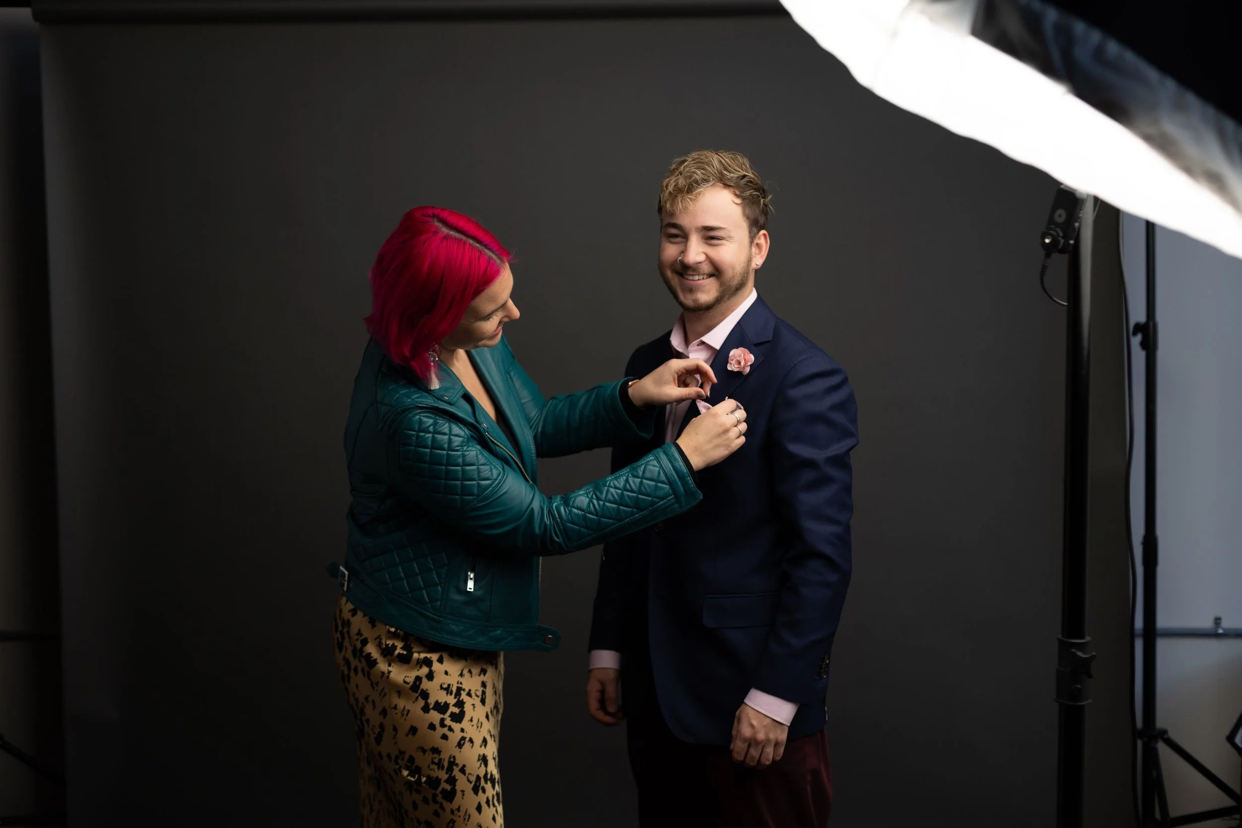 KLV styling a man in a navy suit