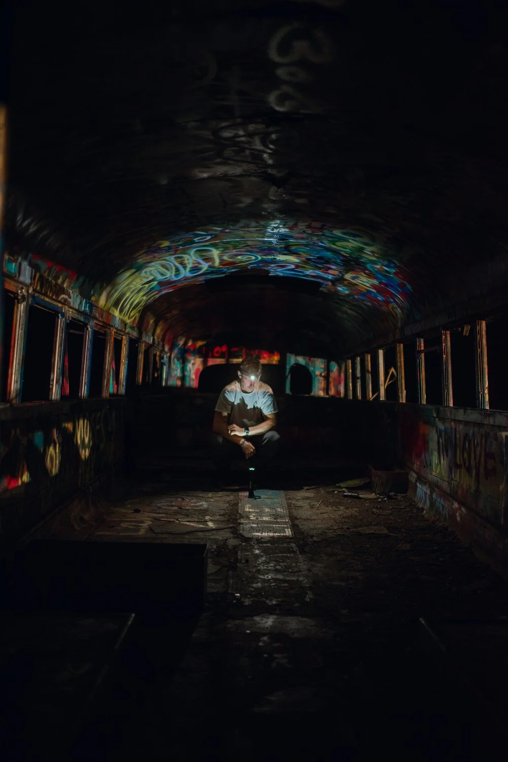 Professional adventure photography in Spokane, Washington - lifestyle portrait in abandoned school bus graffiti