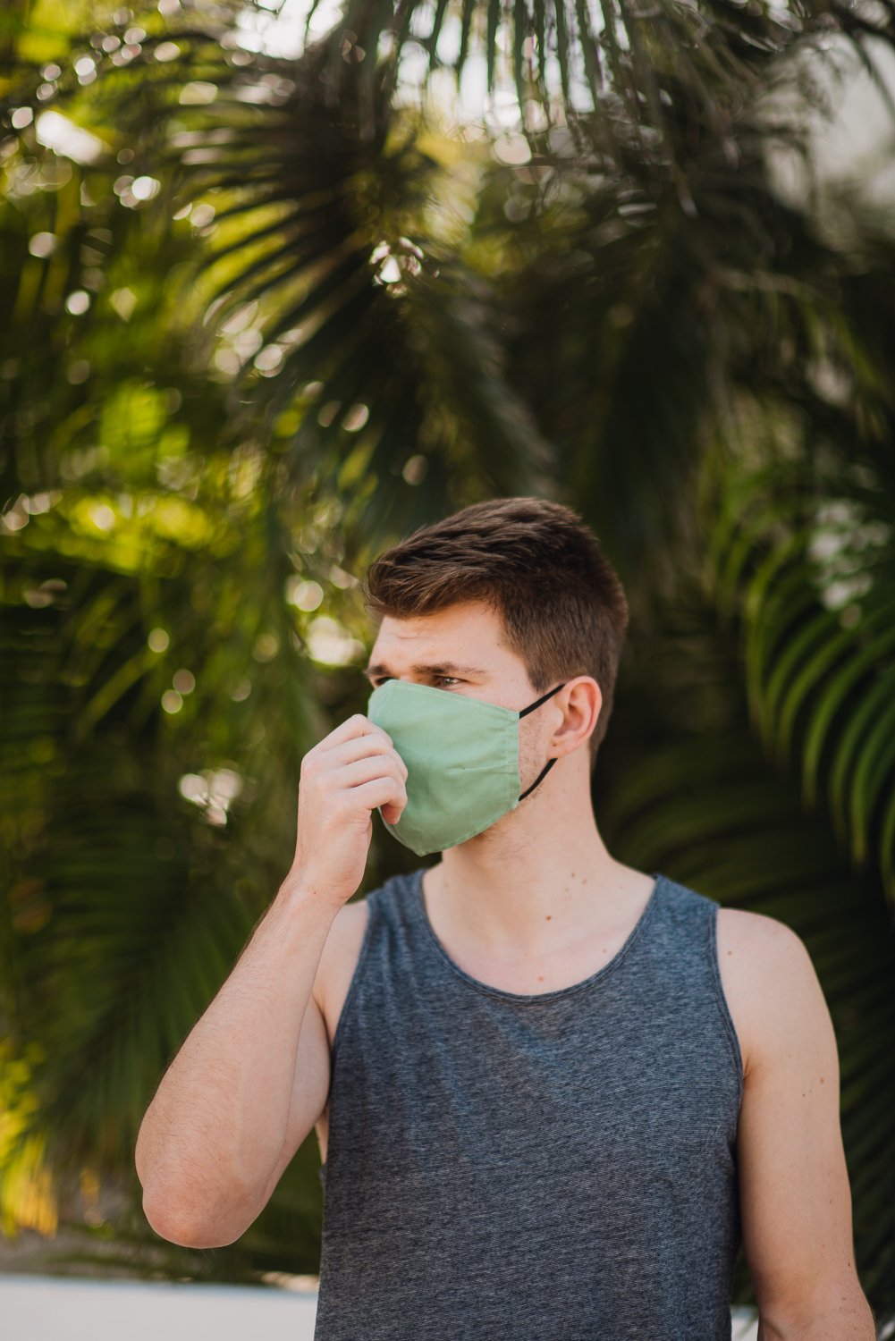 Professional product & branding photography for Sea'sons official face masks - lifestyle portrait with palm leaves in Isla Holbox, Mexico.