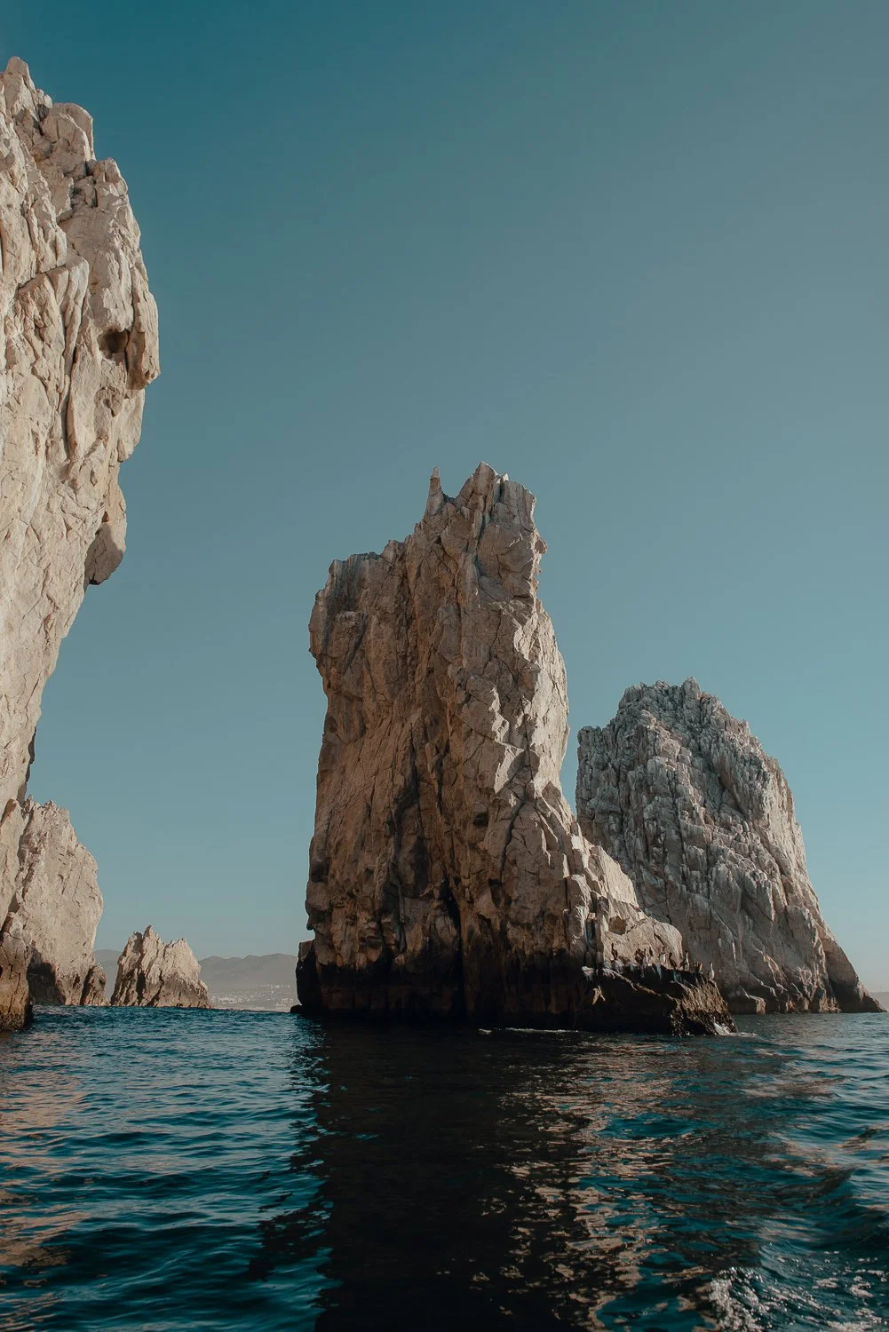 Landscape photography of the famous arch and unique rock formations at Lover's Beach in Cabo San Lucas, Mexico