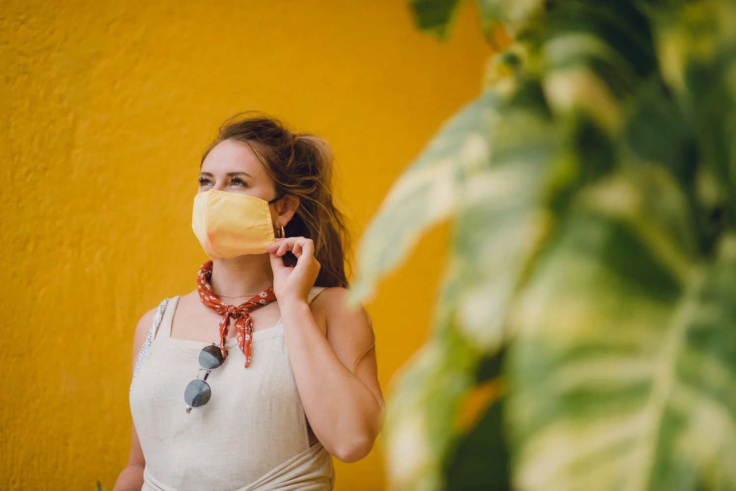 Professional product & branding photography for Sea'sons official face masks - lifestyle portrait with yellow wall in Isla Holbox, Mexico.