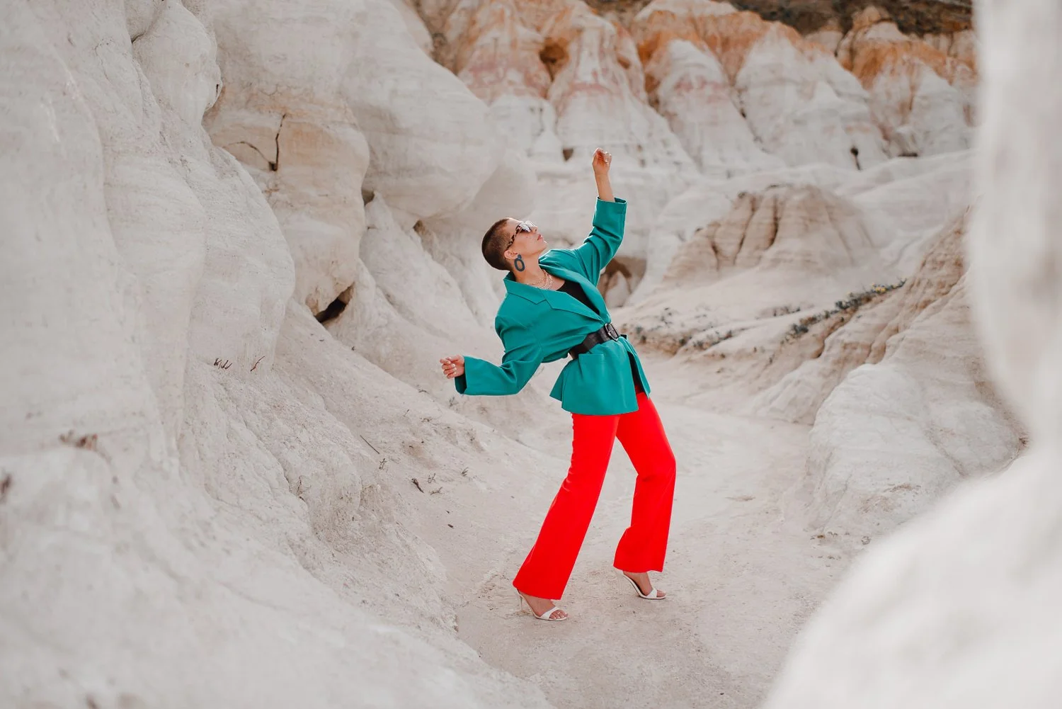 Professional editorial portrait photography at the Paint Mines Interpretive Park in Calhan, Colorado - colorful teal blazer, orange pants