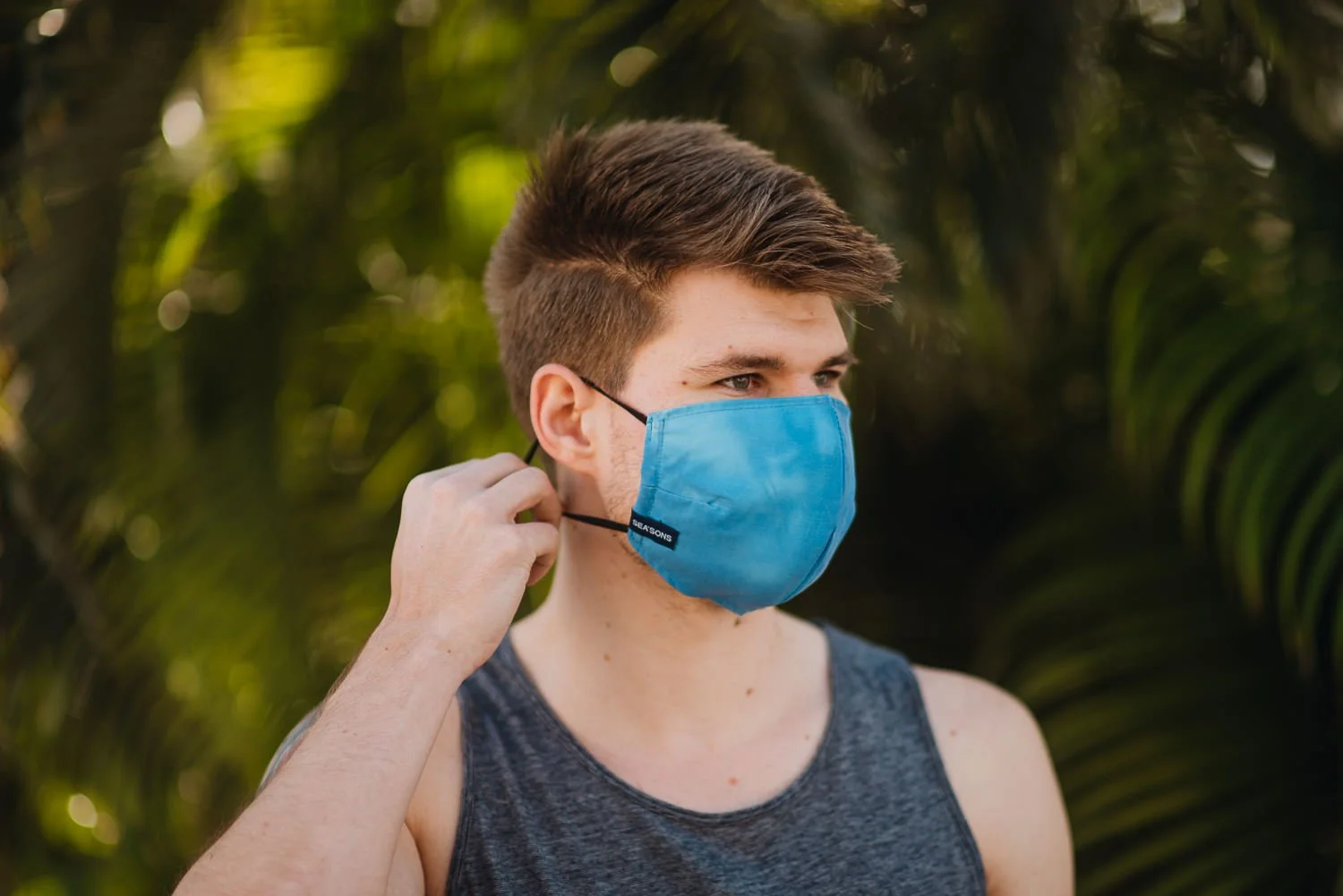 Professional product & branding photography for Sea'sons official face masks - lifestyle portrait with blue mask in Isla Holbox, Mexico.