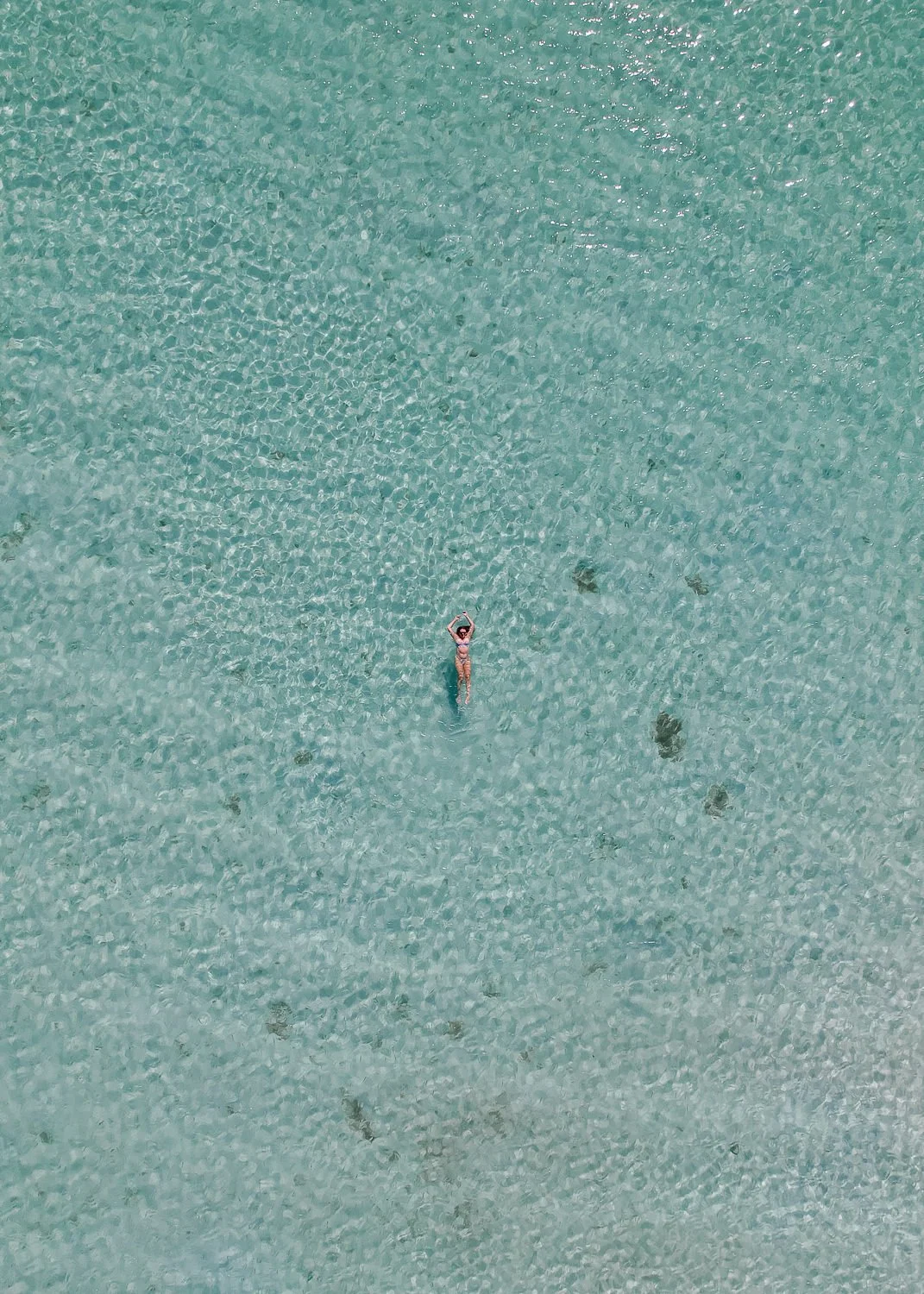 Ryan-Waneka-Photography-2022-La-Paz-Mexico-33-drone-photo-birdseye-view-girl-swimming-playa-pichilingue-clear-aqua-water.jpg