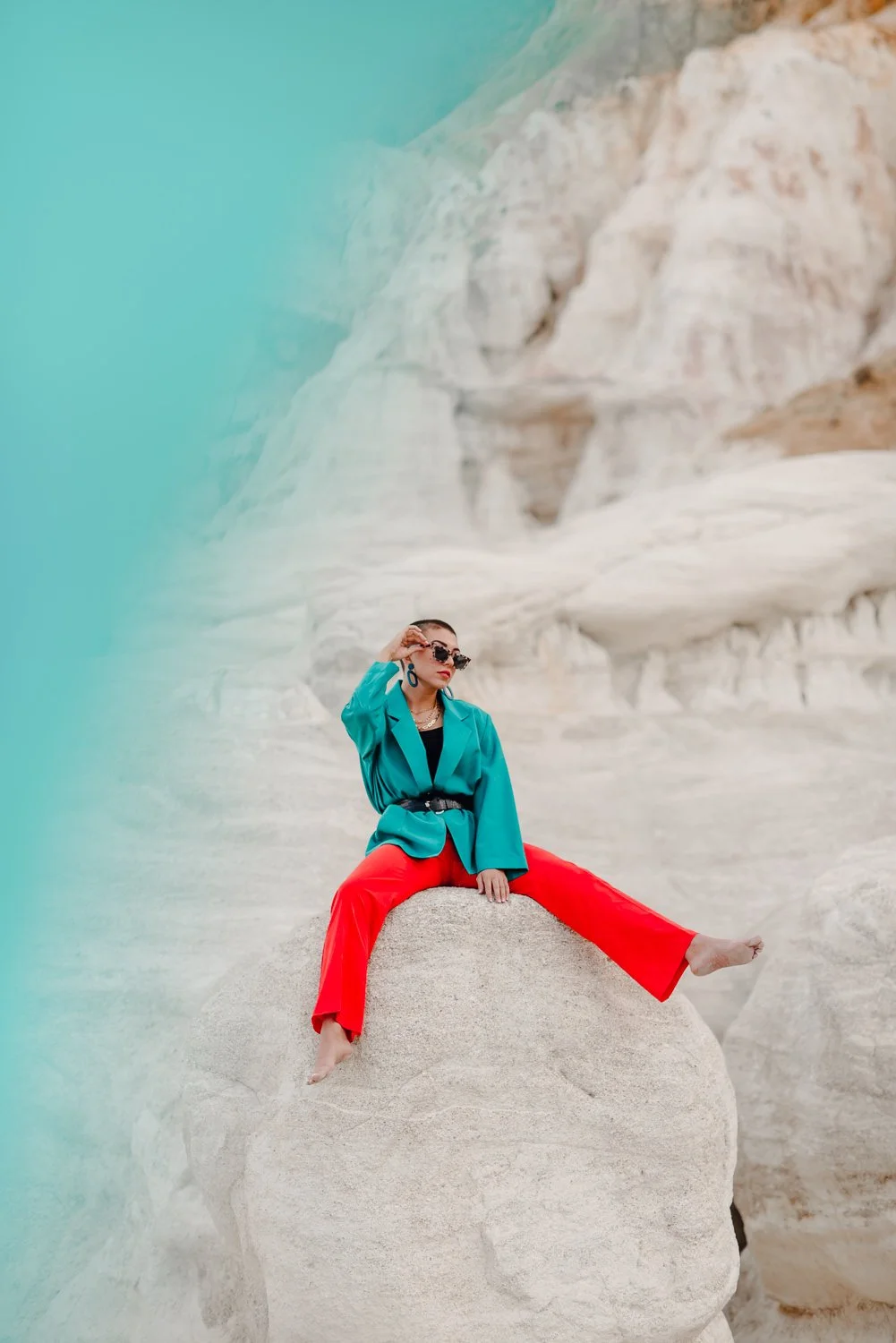 Professional editorial portrait photography at the Paint Mines Interpretive Park in Calhan, Colorado - colorful teal blazer, orange pants