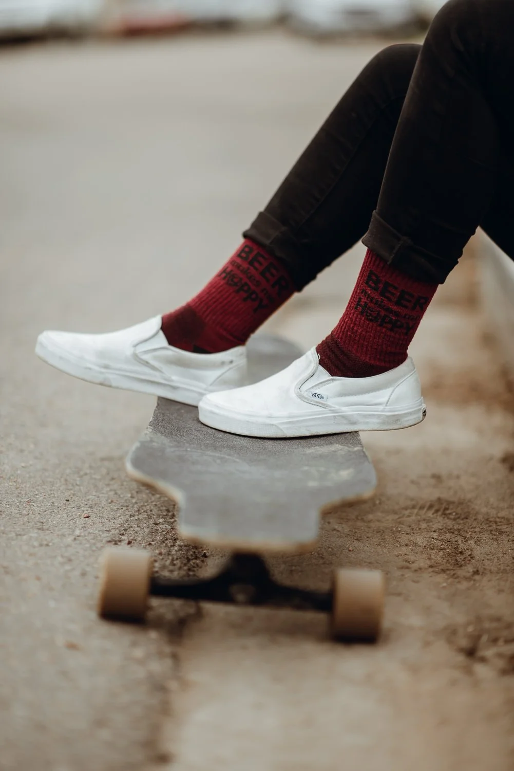 Product photography of feet on a longboard in Manitou Springs, Colorado for Akinz Boardwear