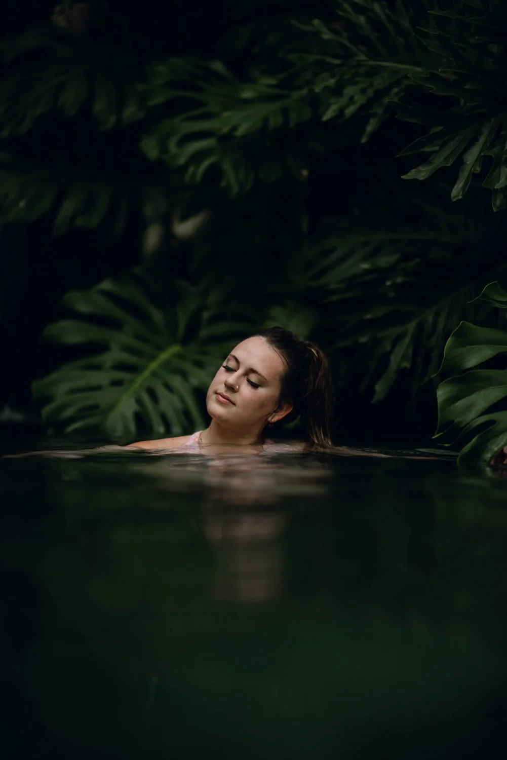 Lifestyle portrait of a girl in a hot spring in La Fortuna, Costa Rica