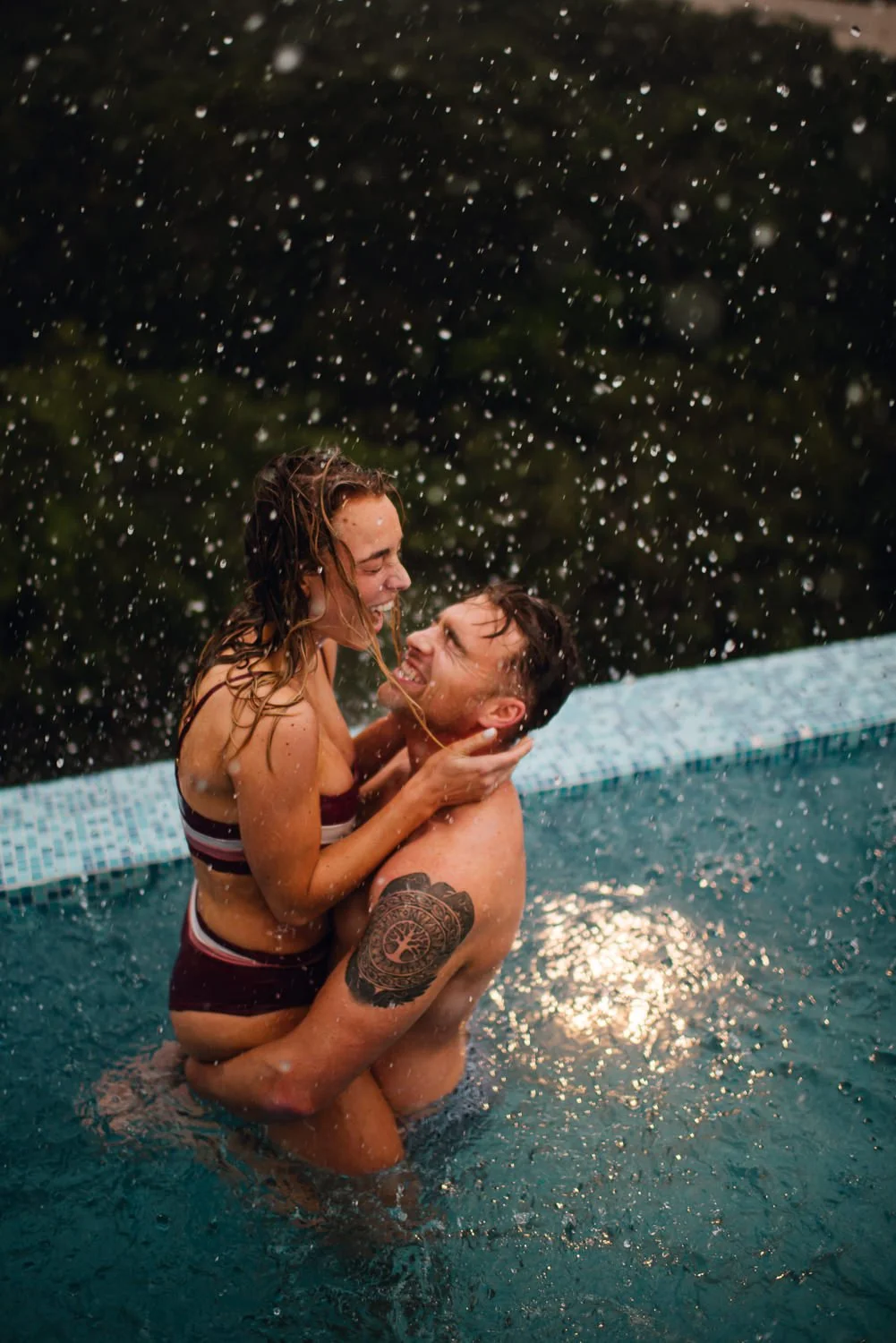 Professional travel couple photography of a cute couple in an infinity pool at a unique airbnb in Tulum, Mexico - airbnb with infinity pool