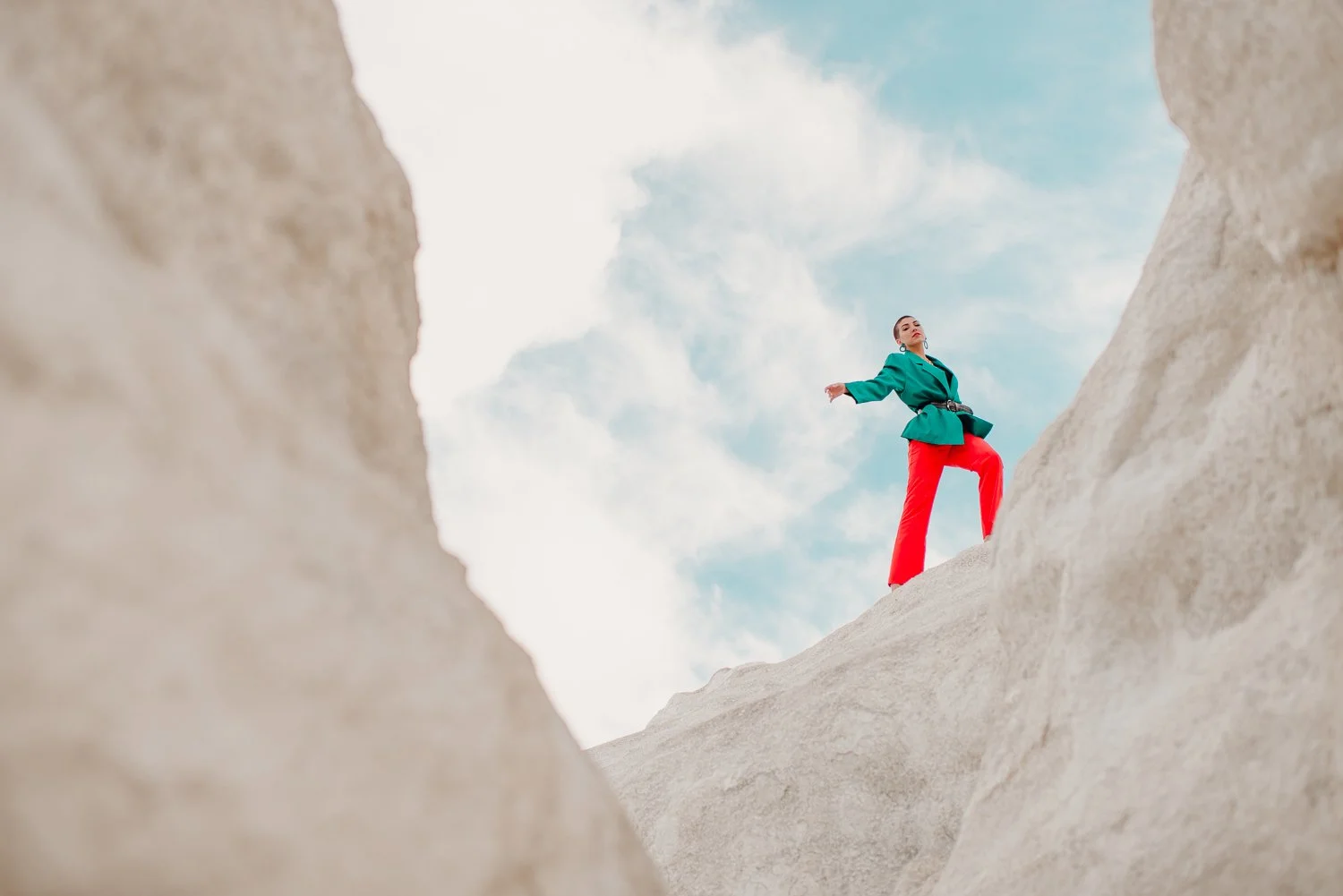 Professional editorial portrait photography at the Paint Mines Interpretive Park in Calhan, Colorado - colorful teal blazer, orange pants
