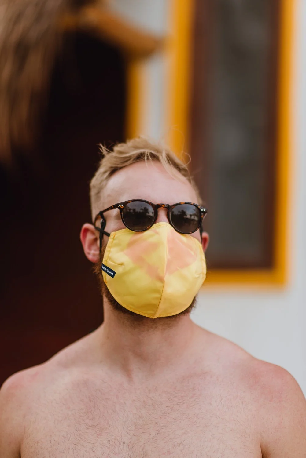Professional product & branding photography for Sea'sons official face masks - lifestyle portrait with yellow mask in Isla Holbox, Mexico.