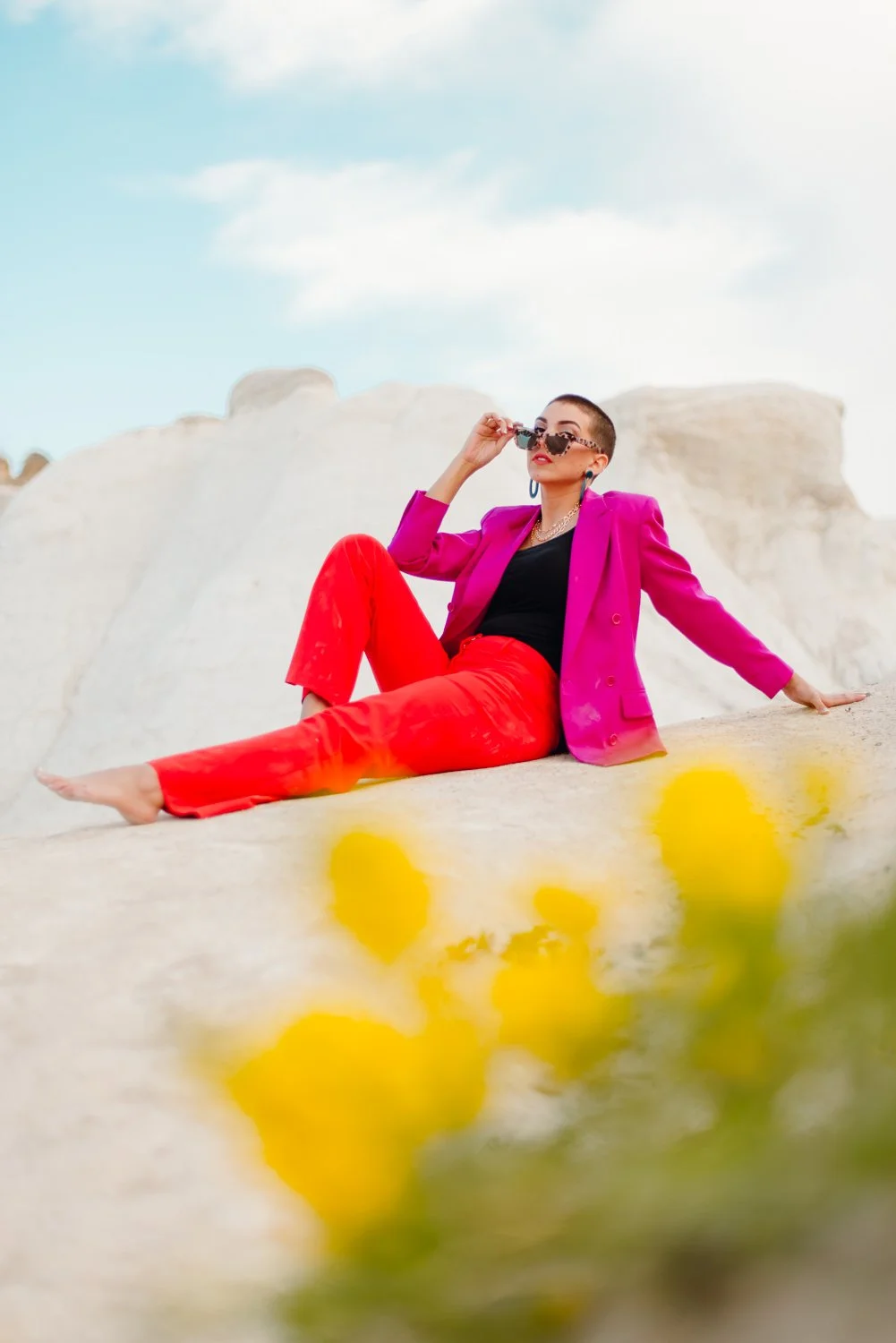 Professional editorial portrait photography at the Paint Mines Interpretive Park in Calhan, Colorado - colorful pink blazer, orange pants