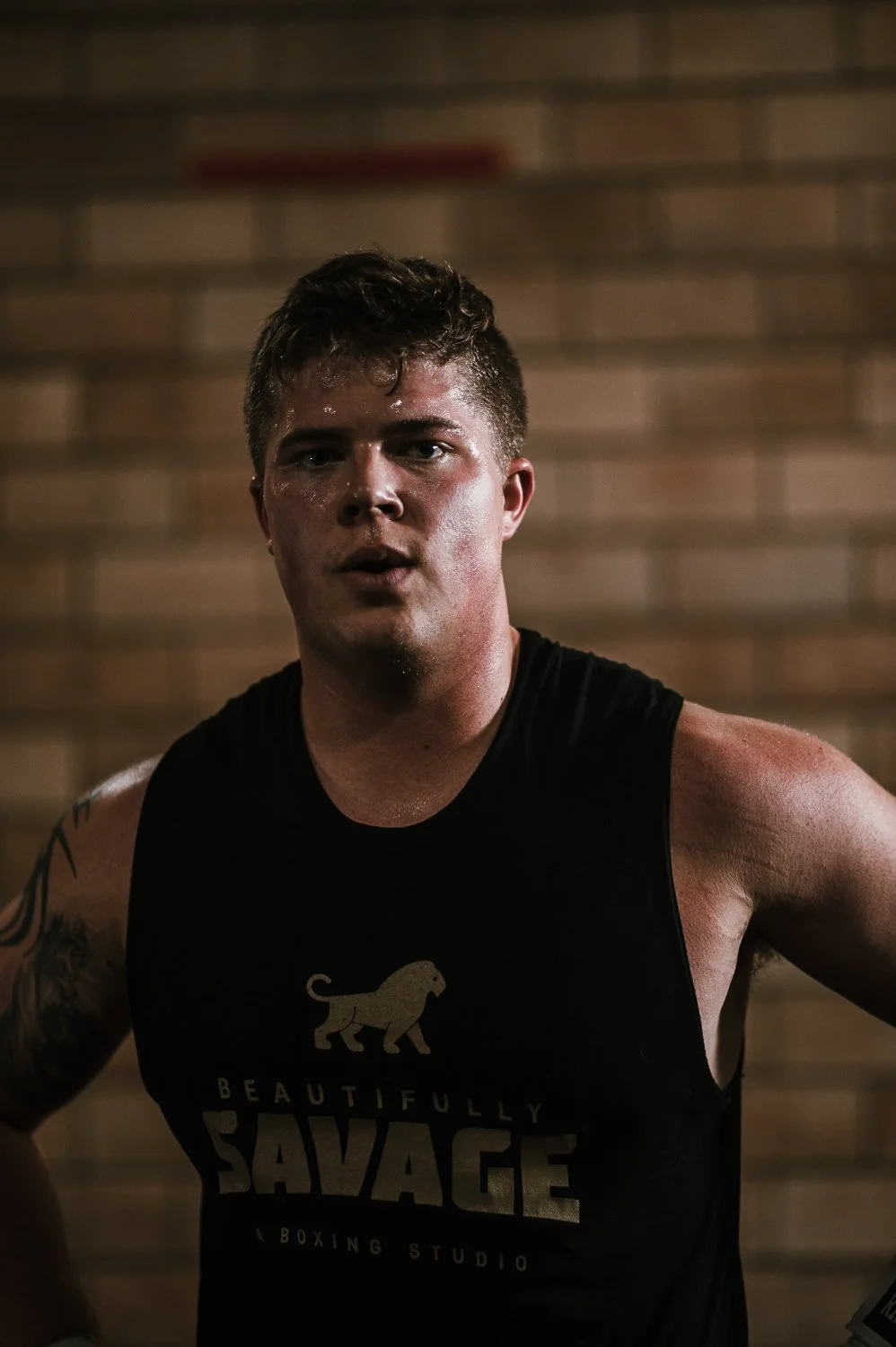 Lifestyle photograph of a young man at Beautifully Savage boutique boxing gym in Fort Collins, Colorado