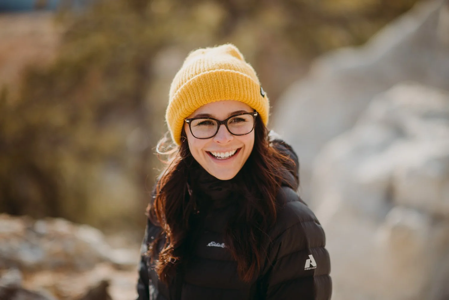 Lifestyle photography of young girl wearing a bright yellow beanie and glasses in Colorado Springs, Colorado for Akinz Boardwear