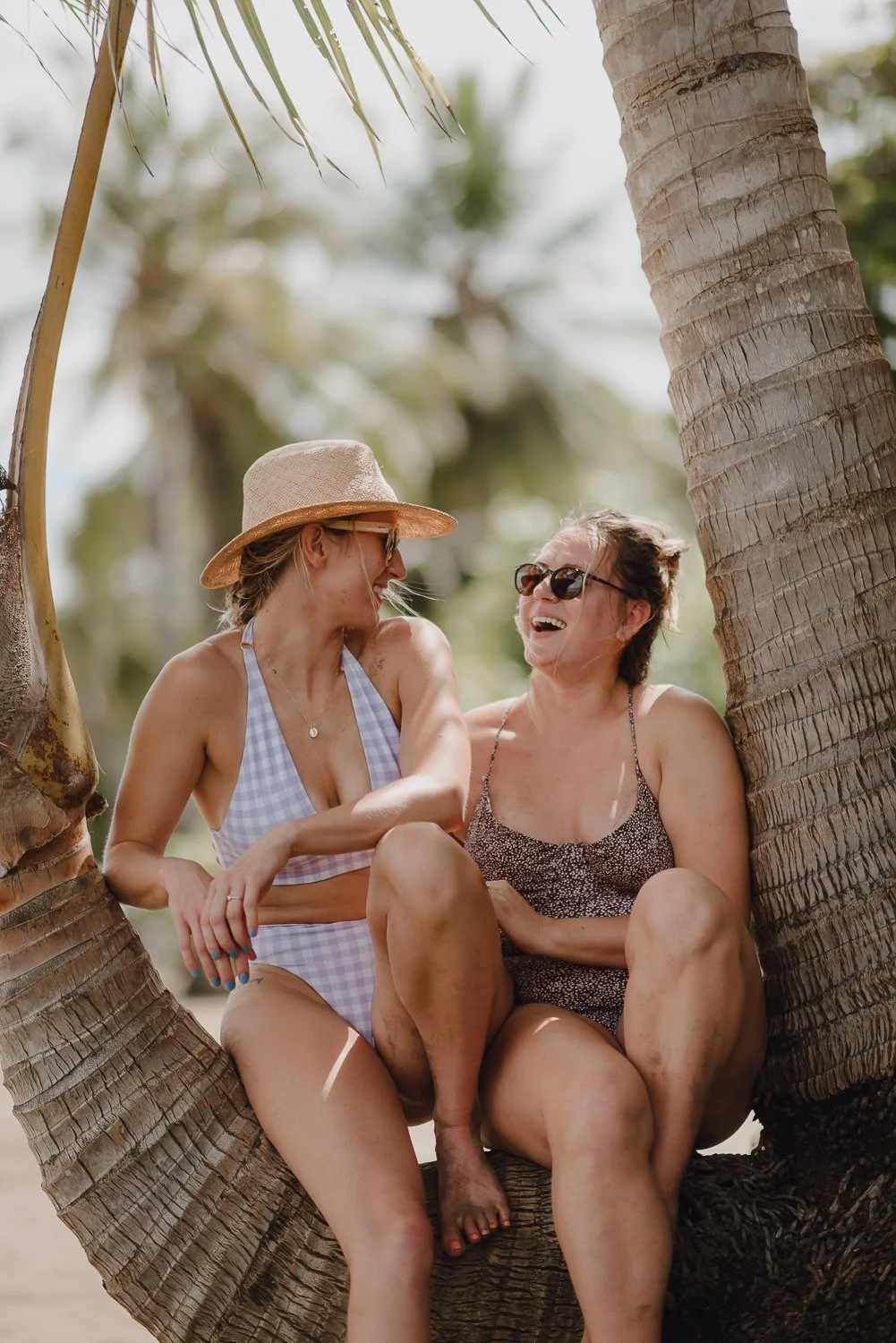 Travel lifestyle photography of girls sitting in a tree at Whale Tail beach in Uvita, Costa Rica