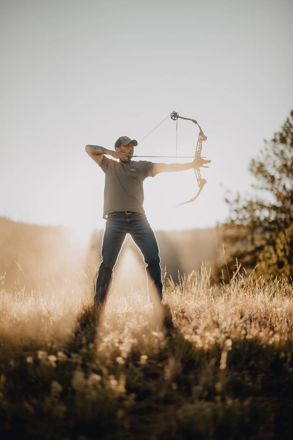Professional destination branding photography for Bison Peak Lodge at Puma Hills in Colorado Rocky Mountains - Lifestyle portrait photography bow and arrow archery