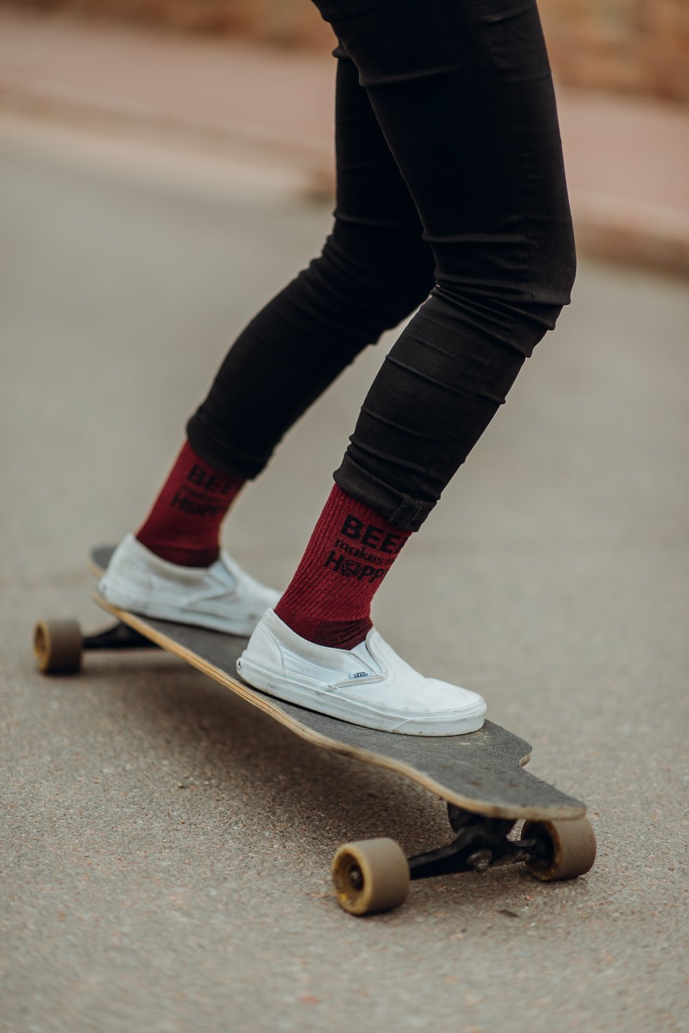 Lifestyle photography of feet on a longboard in Manitou Springs, Colorado for Akinz Boardwear