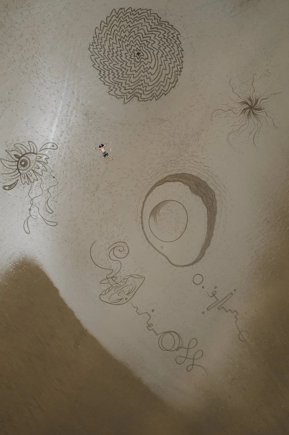 Travel drone photography of sand drawings at the beach in Uvita, Costa Rica