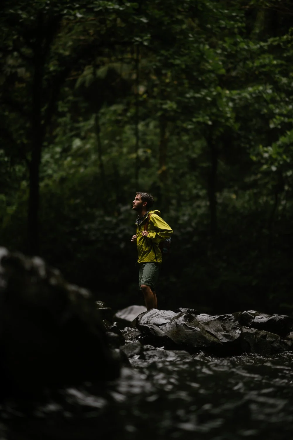 Travel photograph of a young man exploring in the base of La Fortuna waterfall