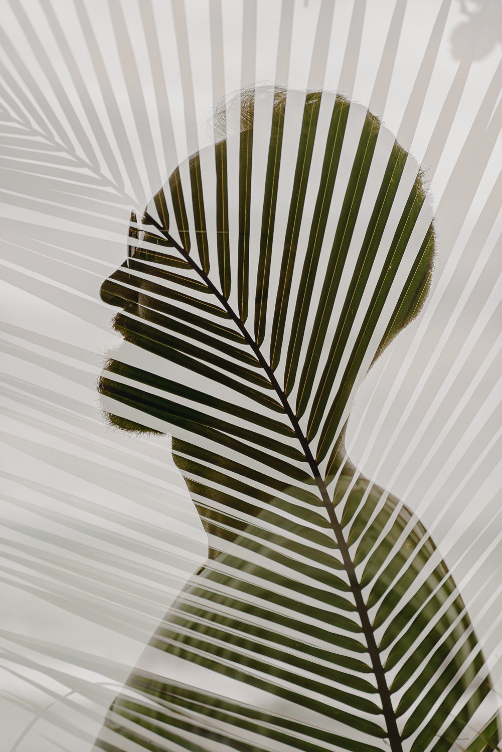 Double exposure portrait of a man and a palm leaf in Uvita, Costa Rica