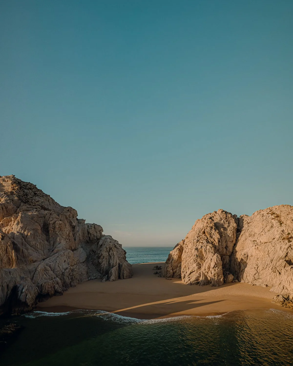 Travel drone photography of the rock formations during sunrise at Lover's Beach in Cabo San Lucas, Mexico