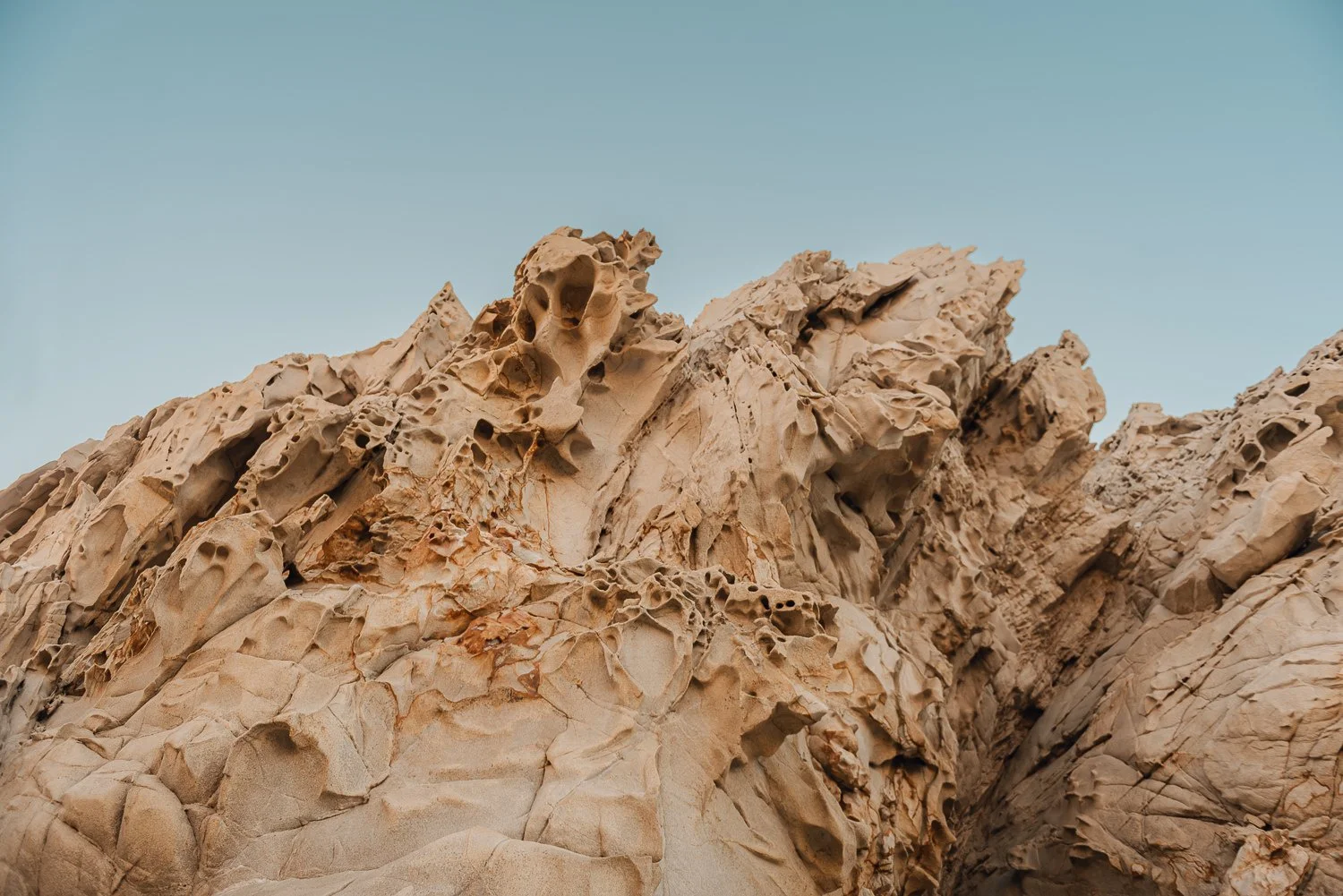 Nature photography of unique rock formations during sunrise at Lover's Beach in Cabo San Lucas, Mexico