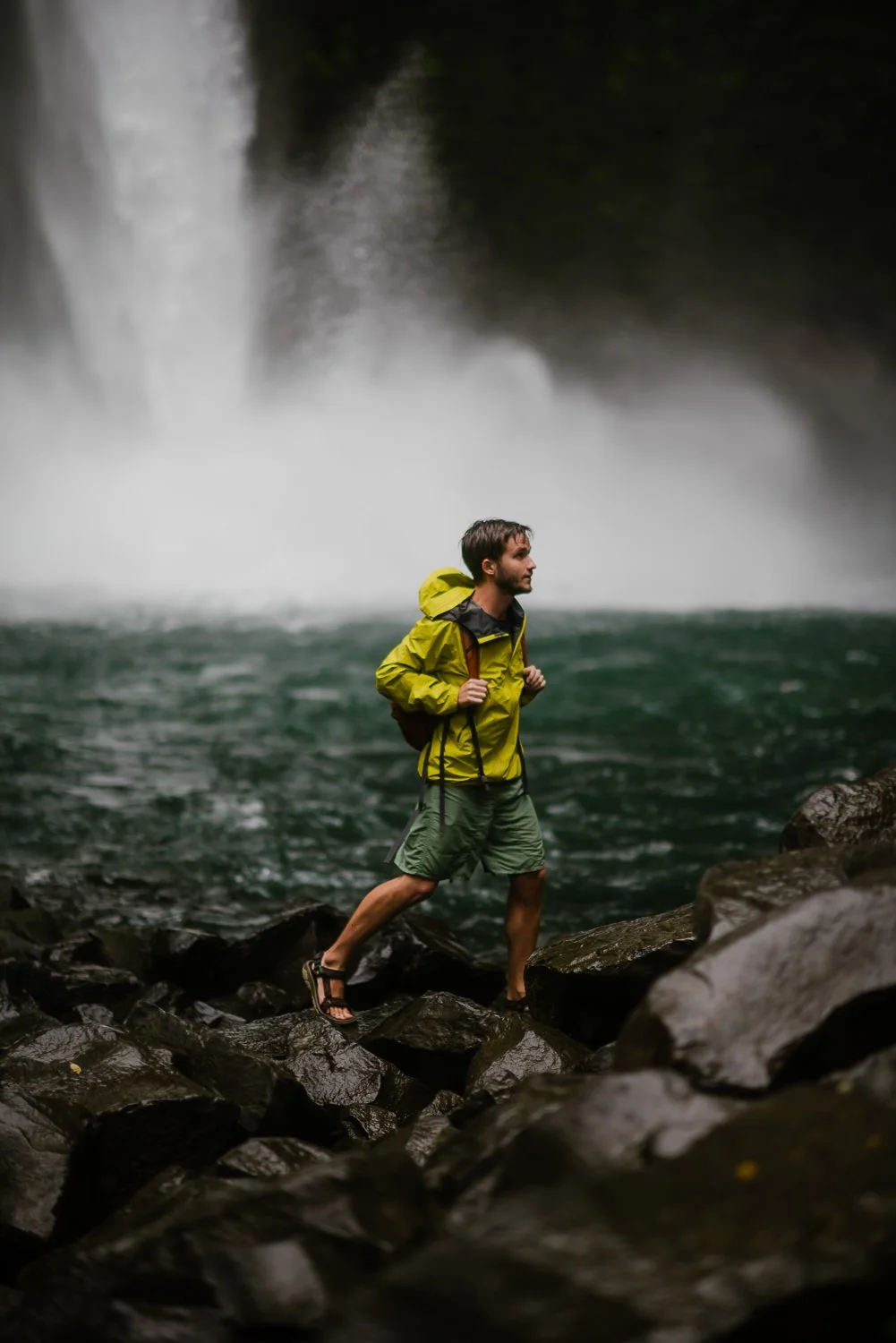Travel photograph of a young man hiking in the base of La Fortuna waterfall