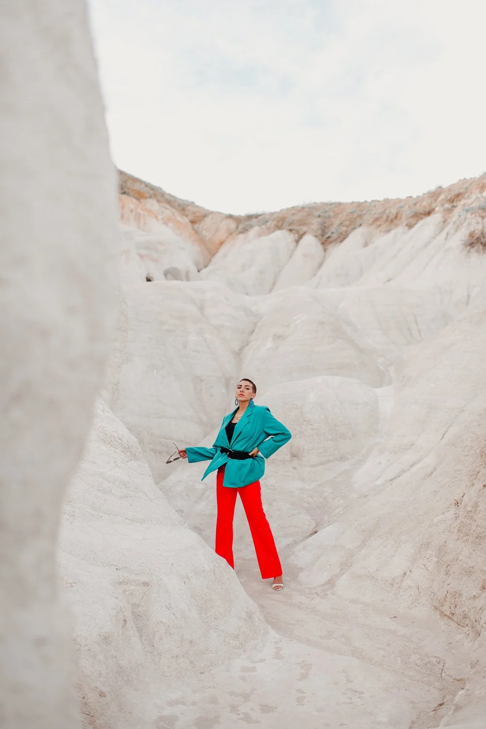 Professional editorial portrait photography at the Paint Mines Interpretive Park in Calhan, Colorado - colorful teal blazer, orange pants