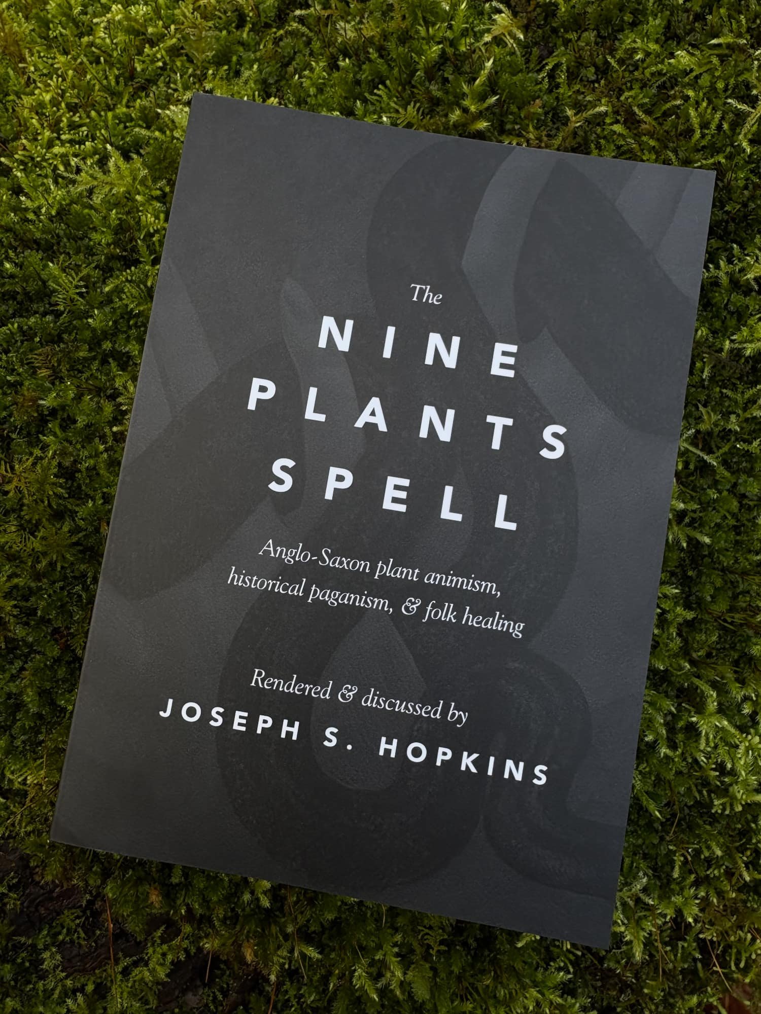 Photograph of cover of the Nine Plants Spell on a bed of mess