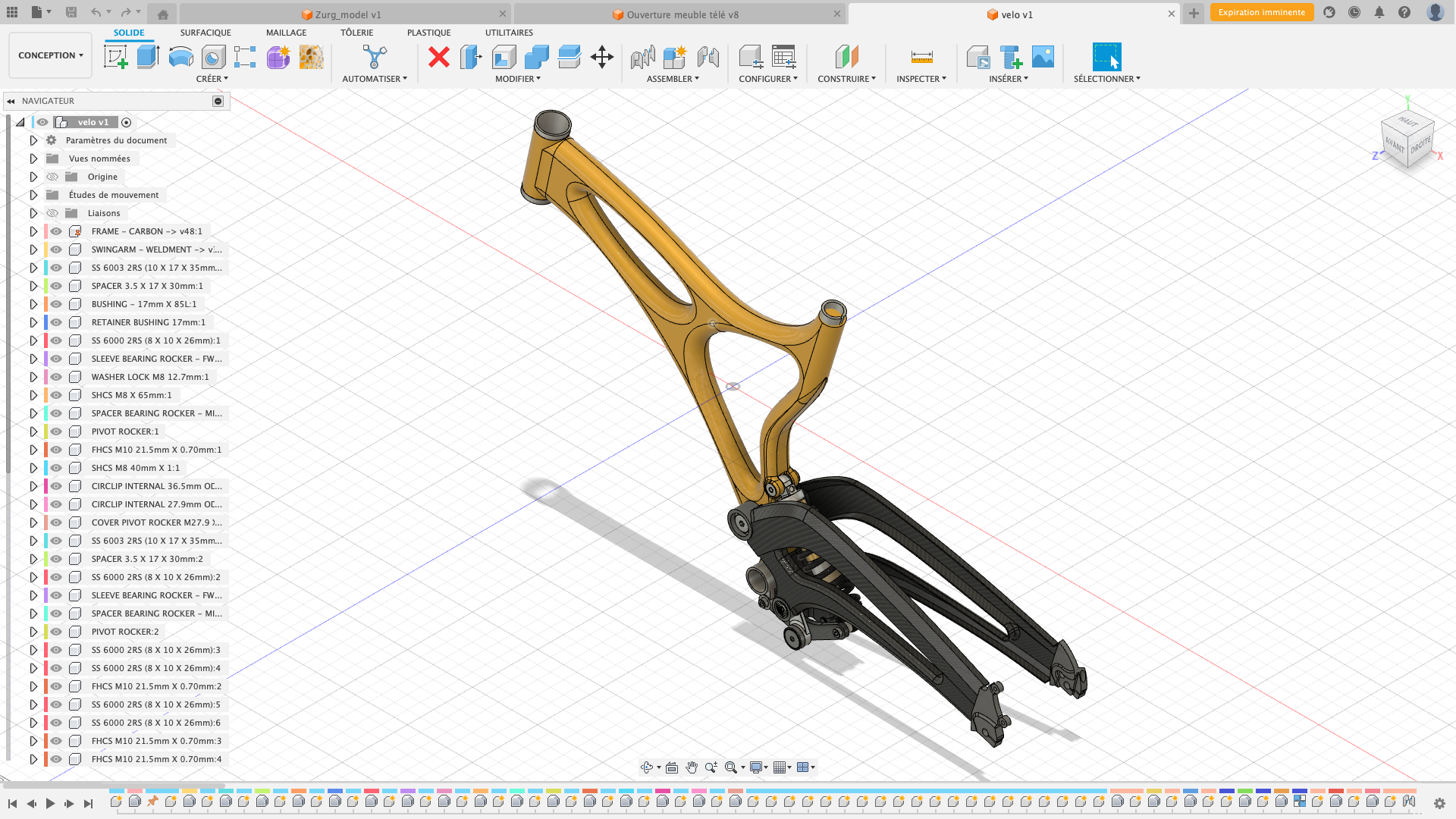 Modèle 3D d'une fourche de vélo, en cours de conception dans un logiciel de modélisation. La fourche est principalement noire avec une partie en couleur or.